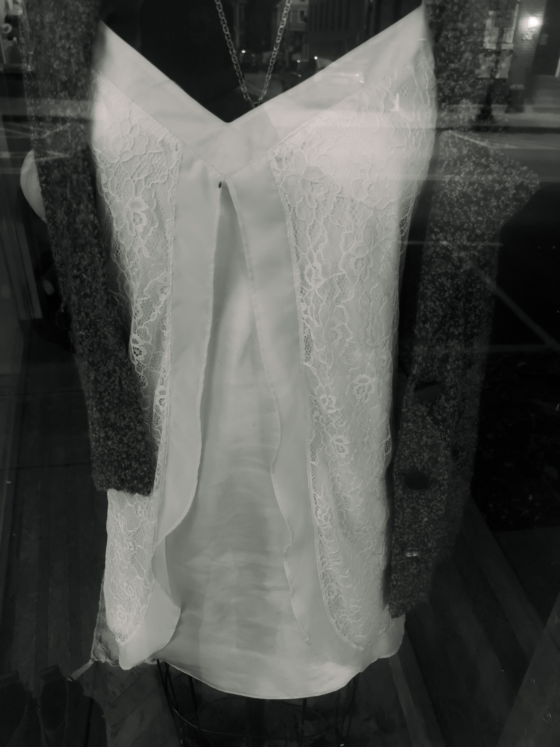 Women’s shirt dress on mannequin in shop window.