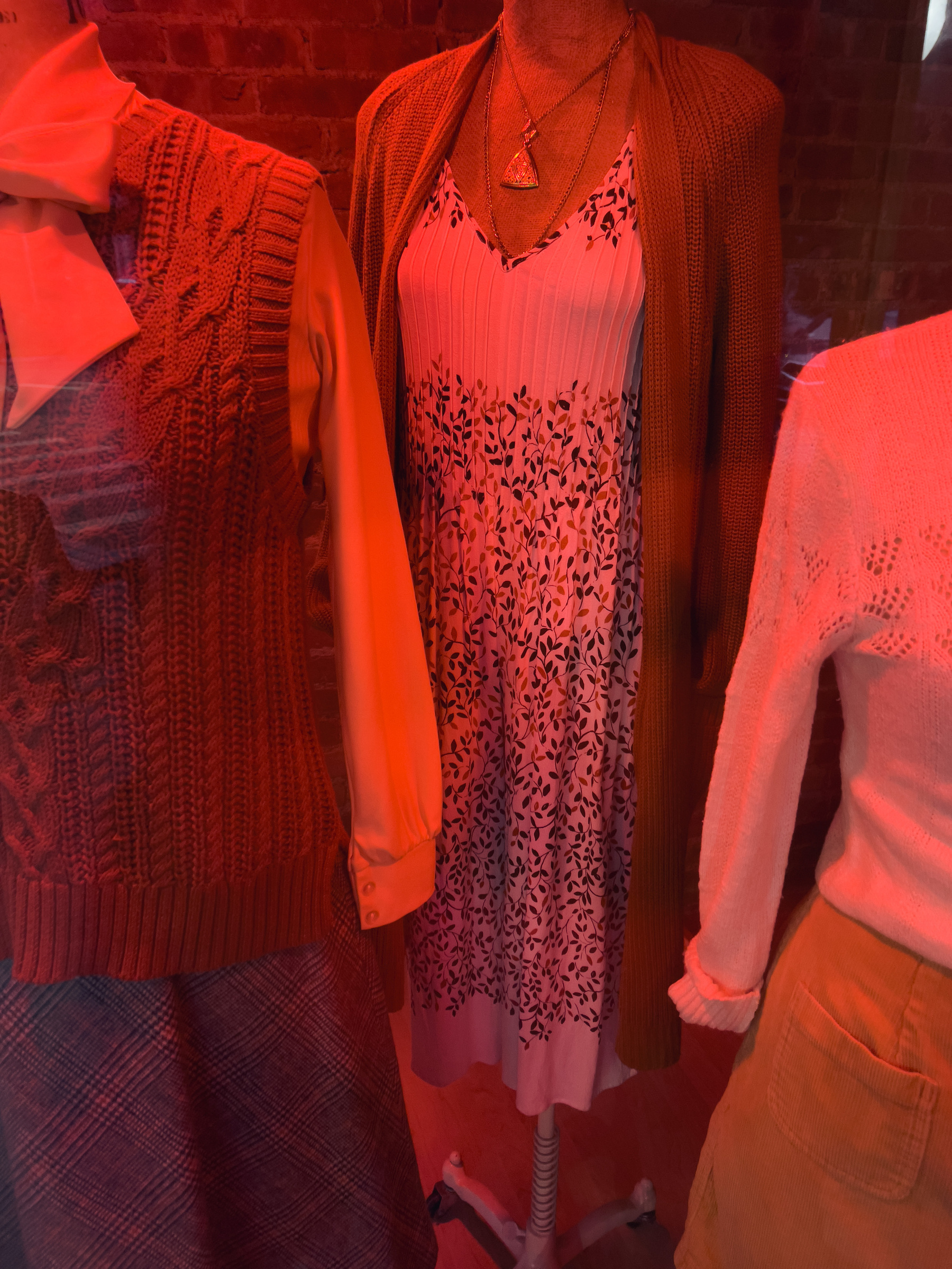 Women’s flower print sundress on mannequin in shop window.