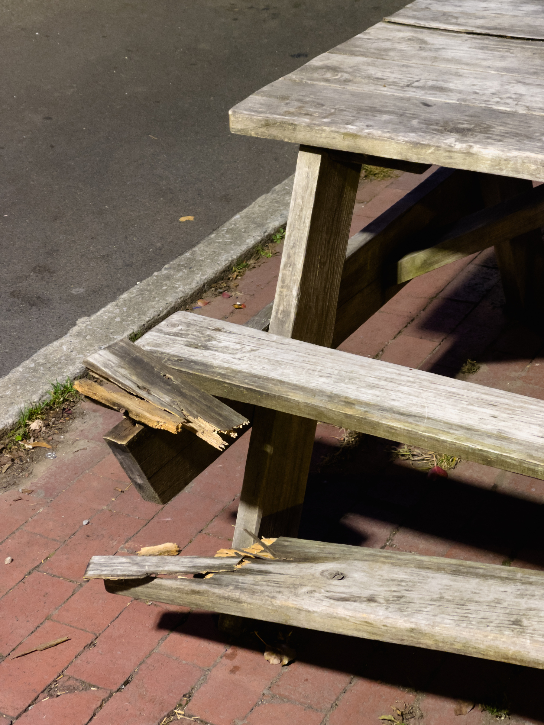 End of a picnic table with broken seat.