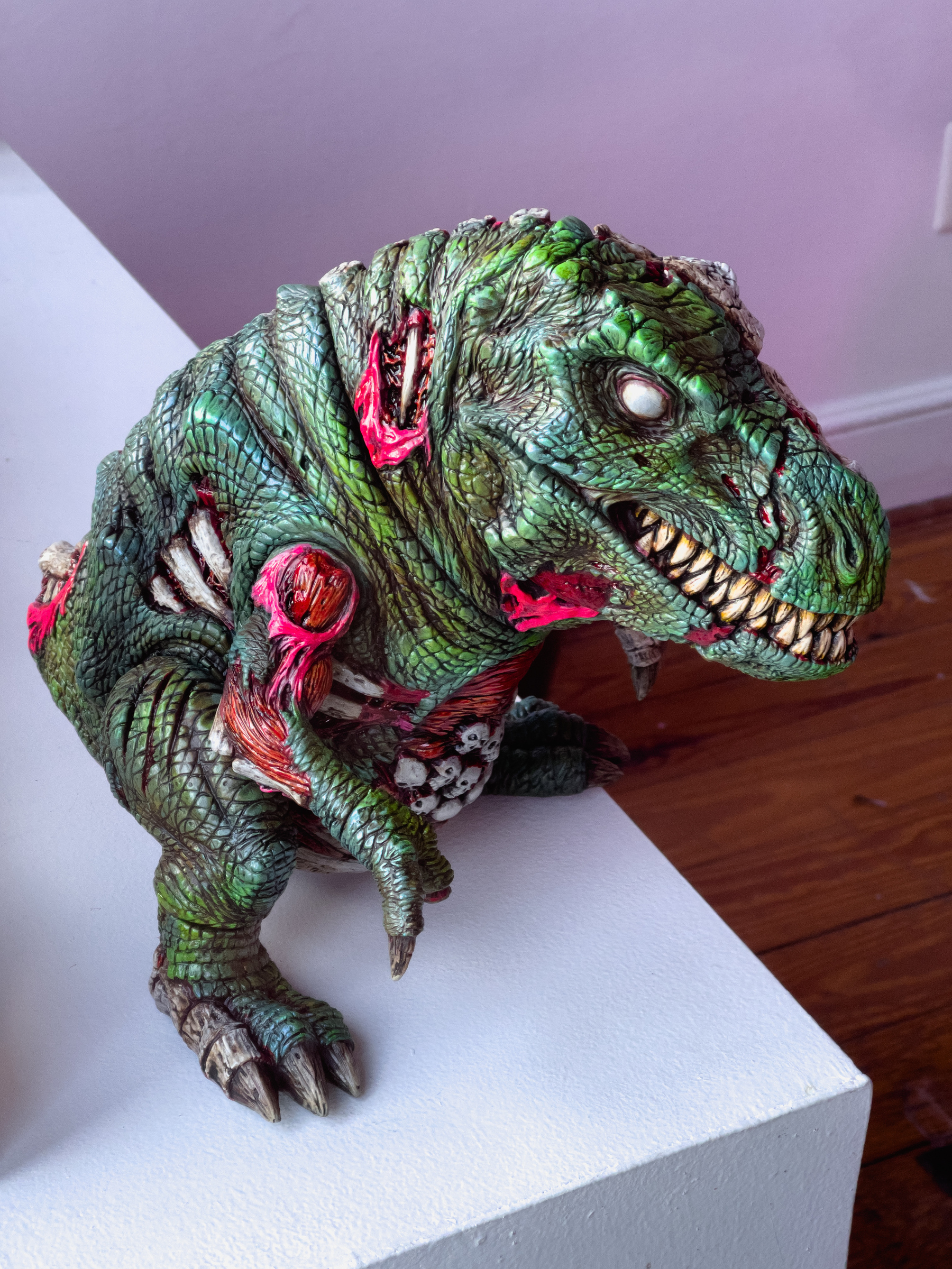 T Rex type dinosaur plastic toy in a high end gallery show.