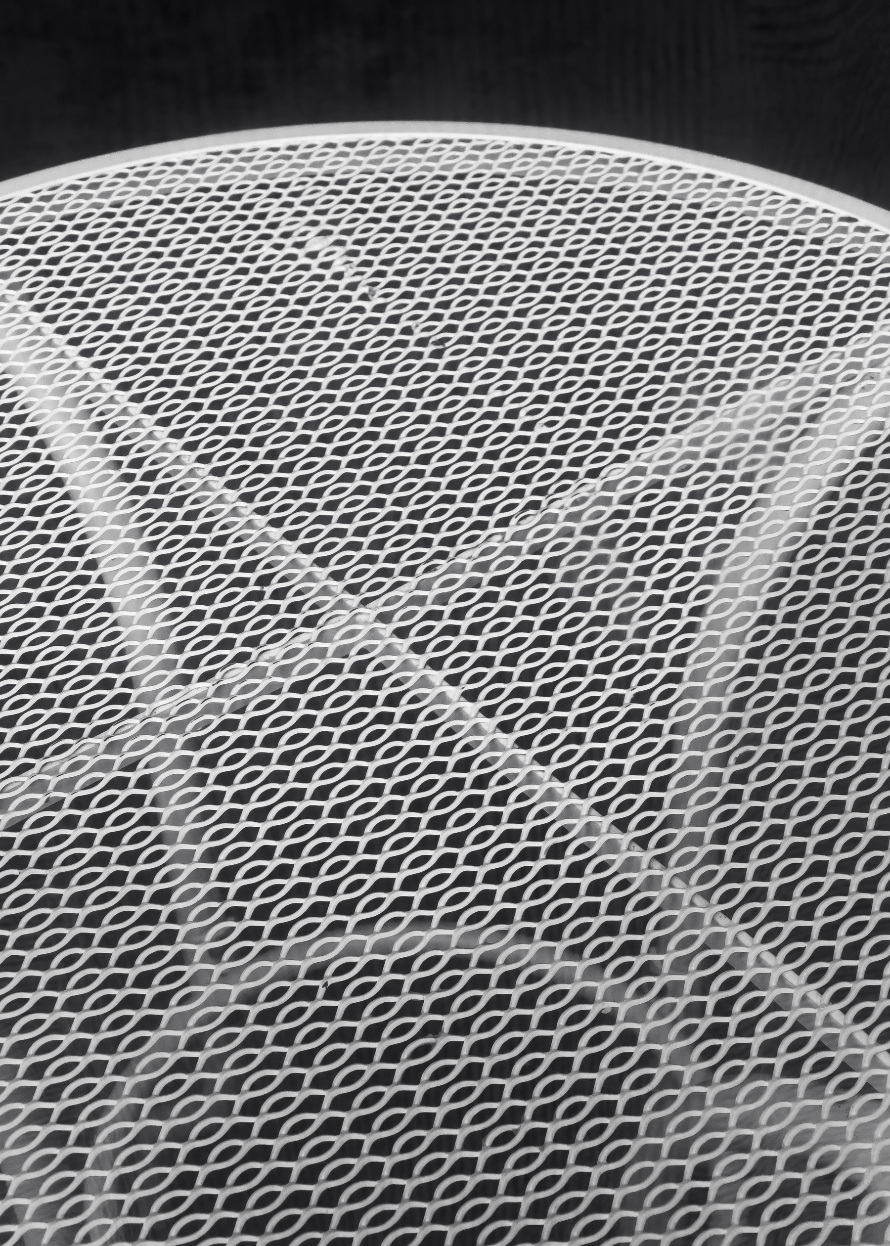 perferated metal mesh table surface with support structure visible underneath 