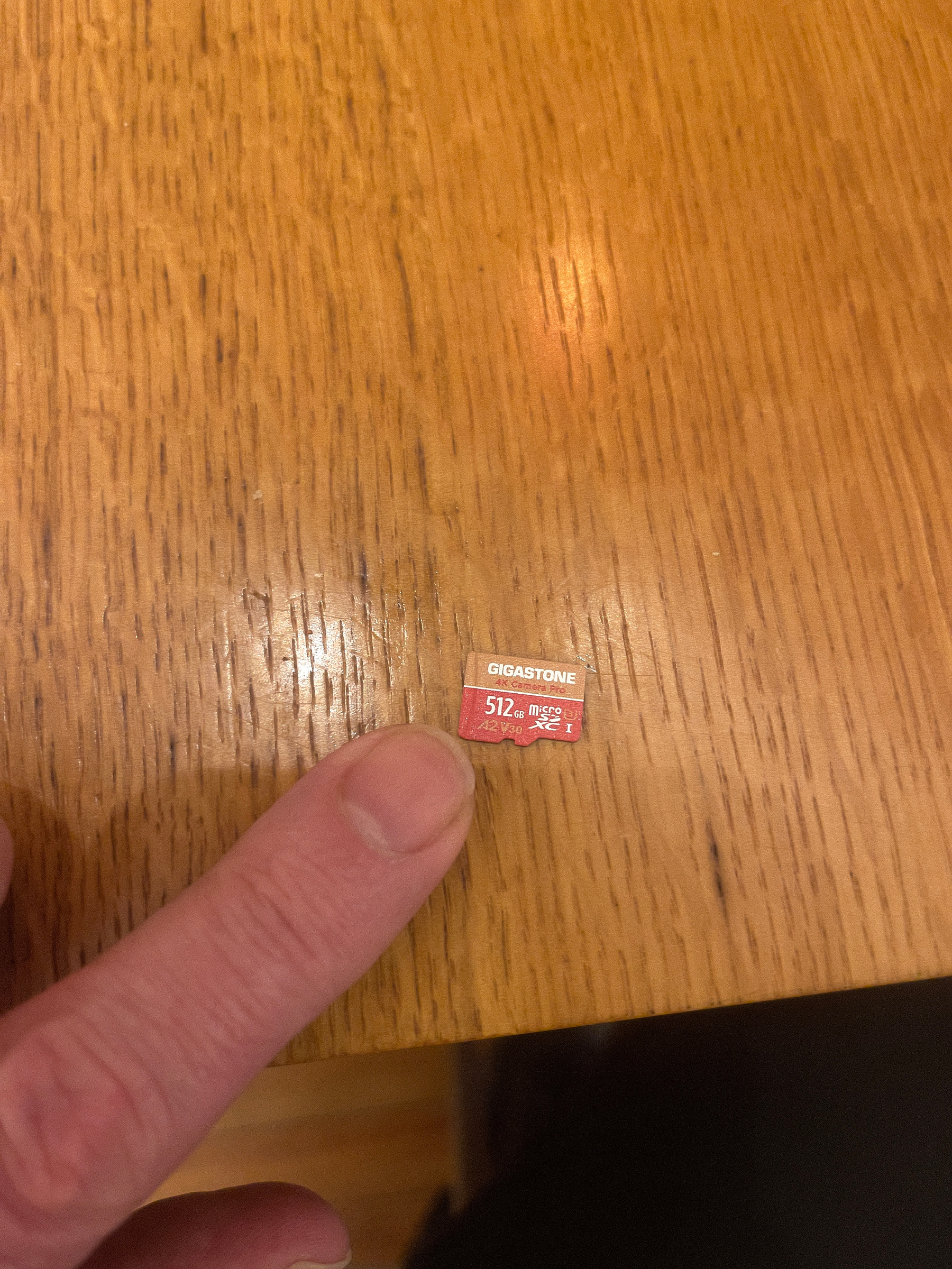 half terabyte micro sd card next to index finger for scale