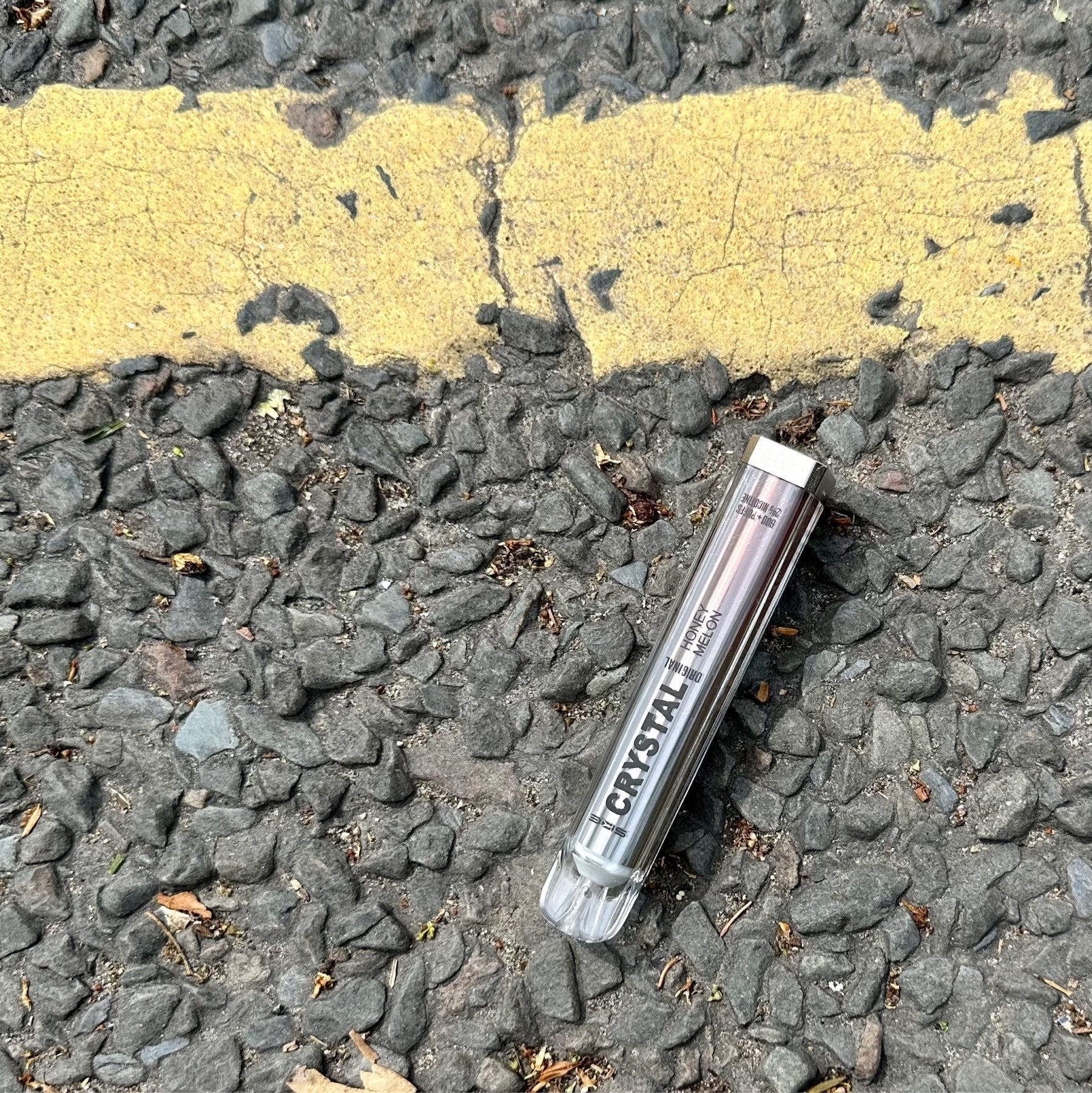 Disposable vape lying discarded in the road