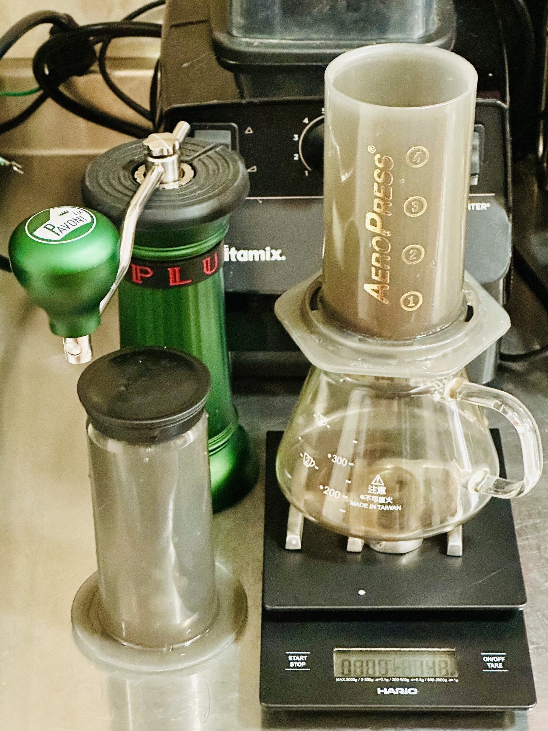 AeroPress set up on digital scale with manual grinder beside it