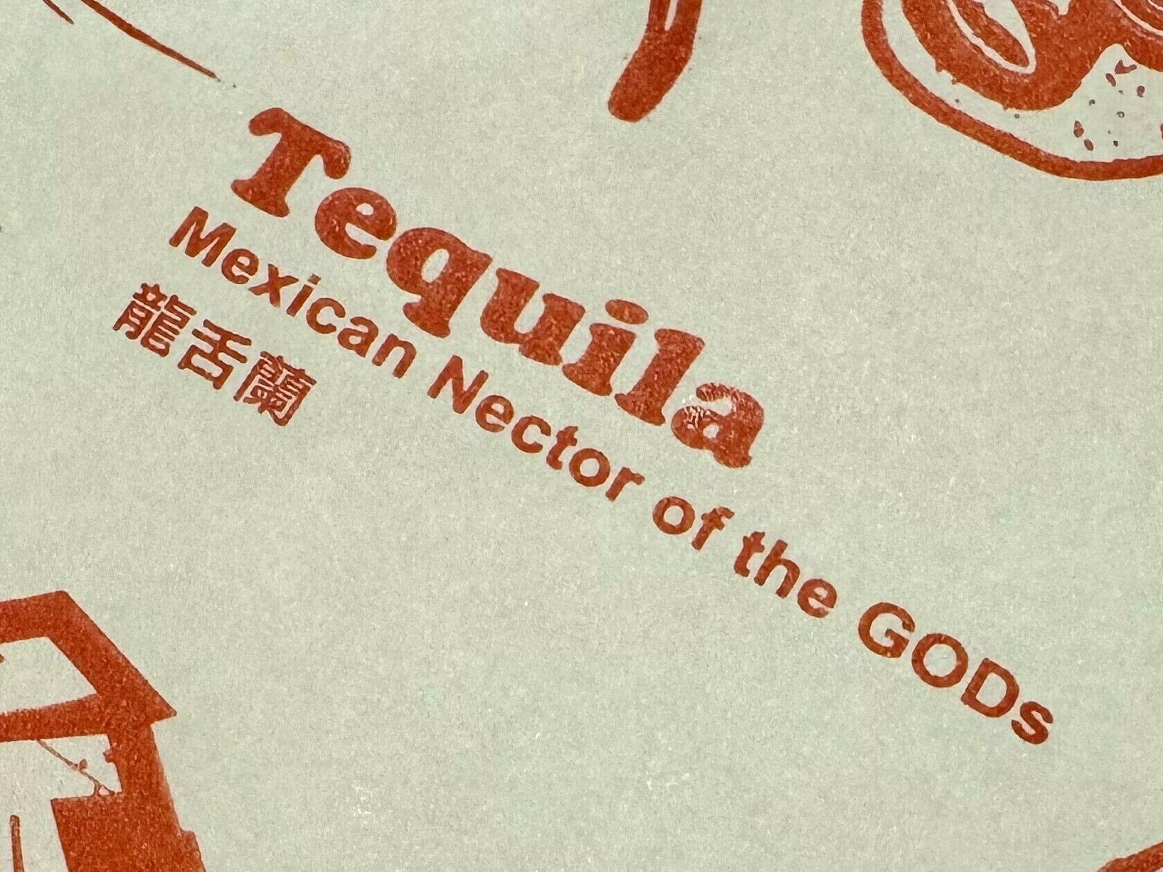 A piece of paper with "Tequila. Mexican Nector (sic) of the GODs" typed on it in red ink
