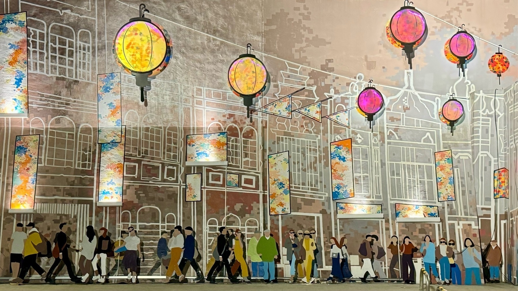 Mural of a street scene, with hues of gold, and several yellow and red lanterns overhead appearing as though lit.