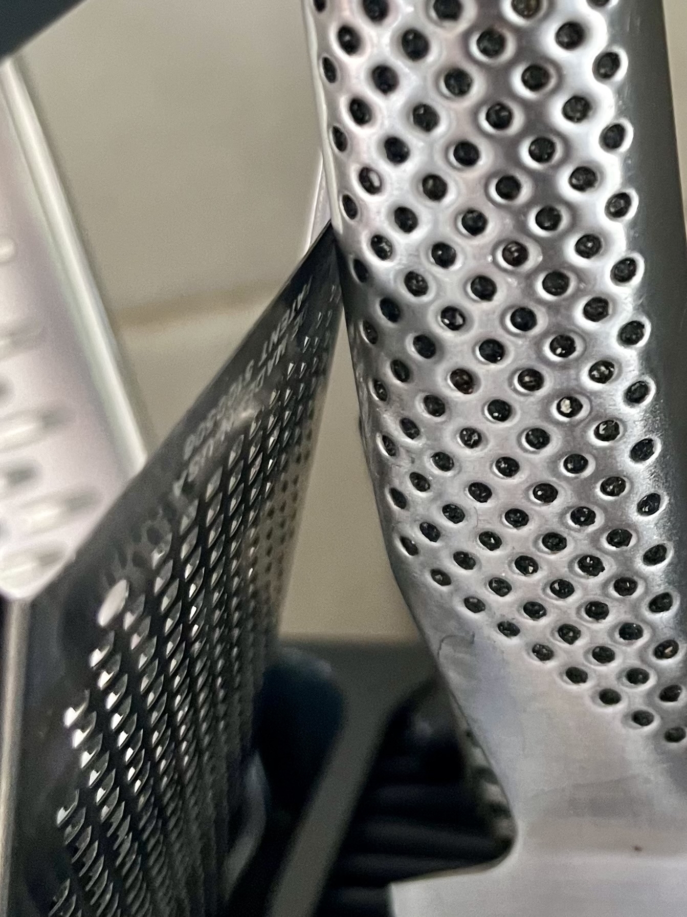 A dotted knife and microplane grater, close up. 