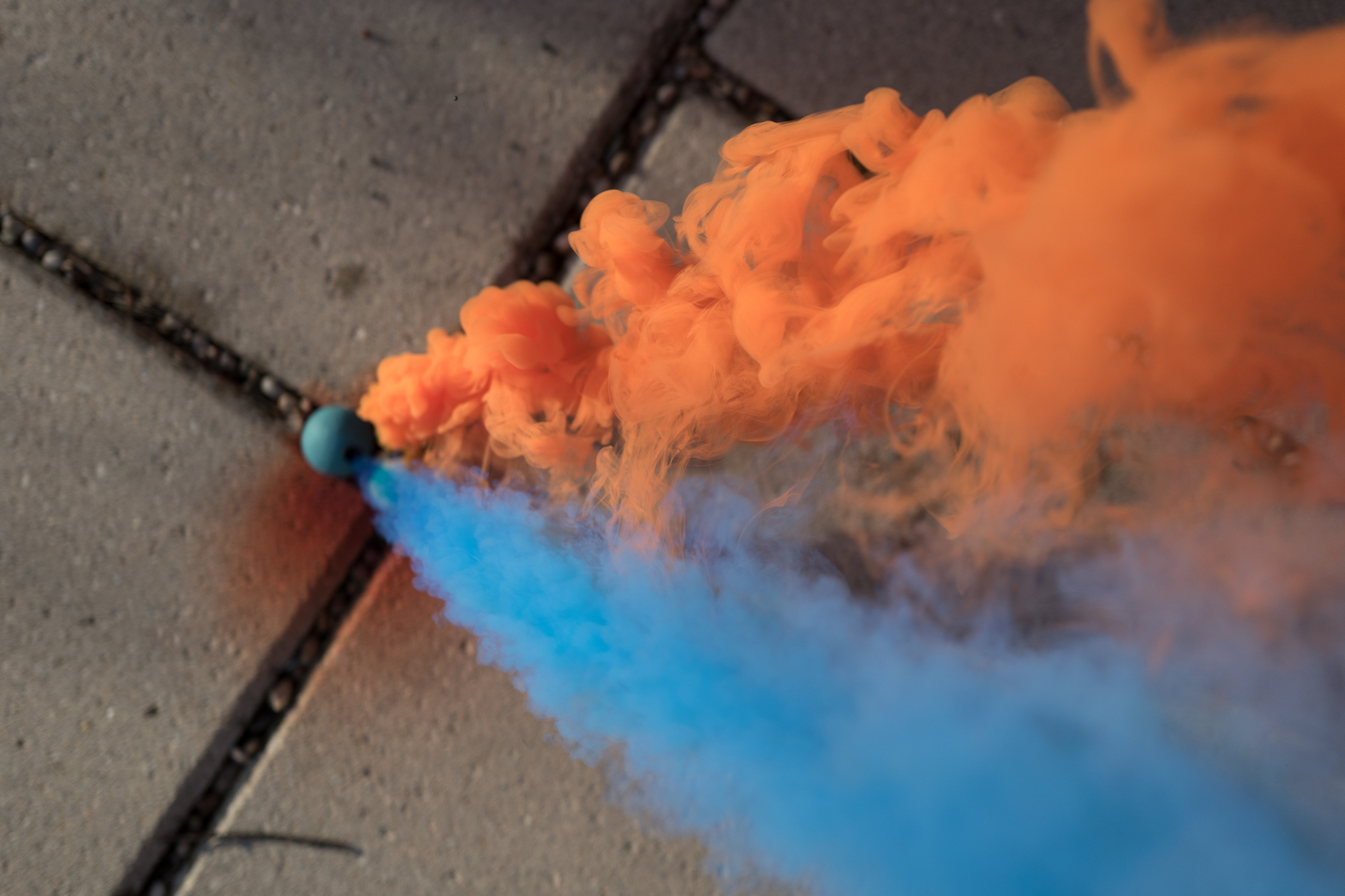 Orange and blue smoke bombs on concrete tiles - Leica Q