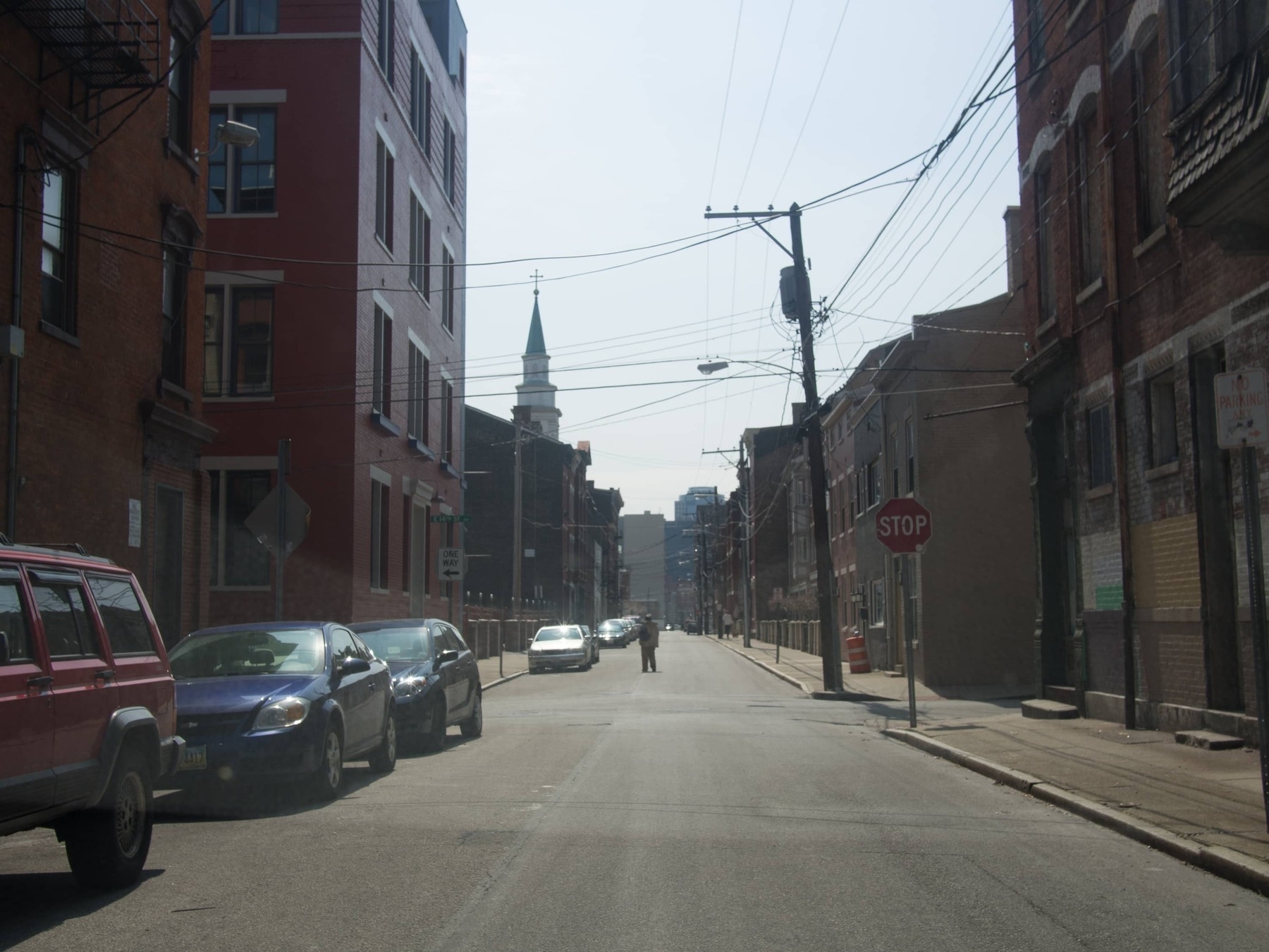 Man stands in the middle of a street in the city of Cincinnati - Olympus E-M5