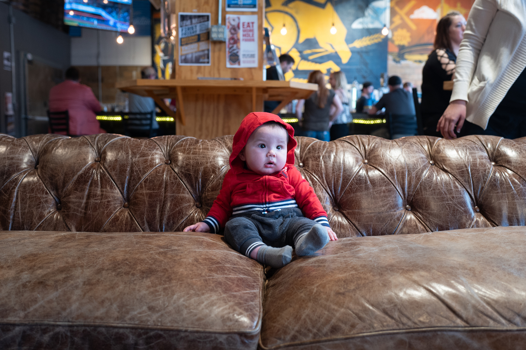 Toddler in red hoody on leather couch - Leica Q