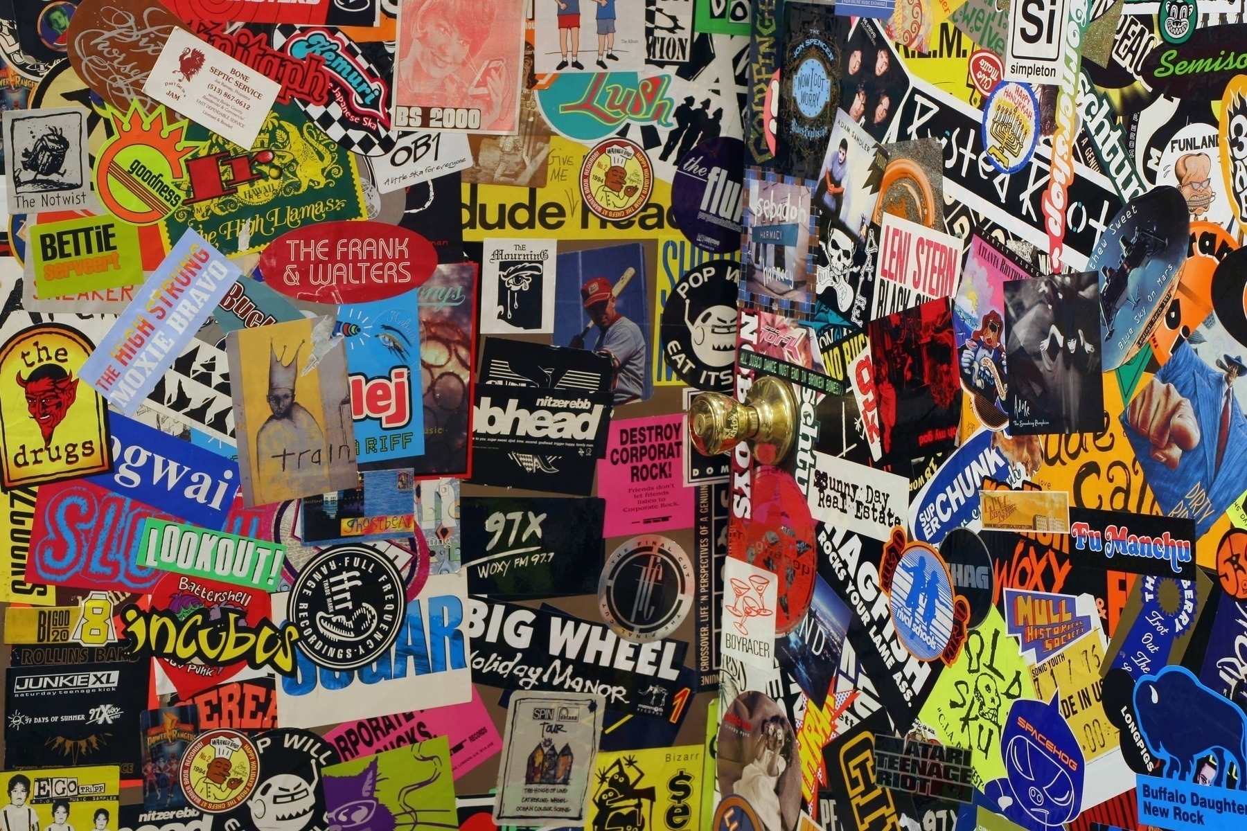 A bunch of indie band stickers from the early 2000's on a wall and door - Canon 20D