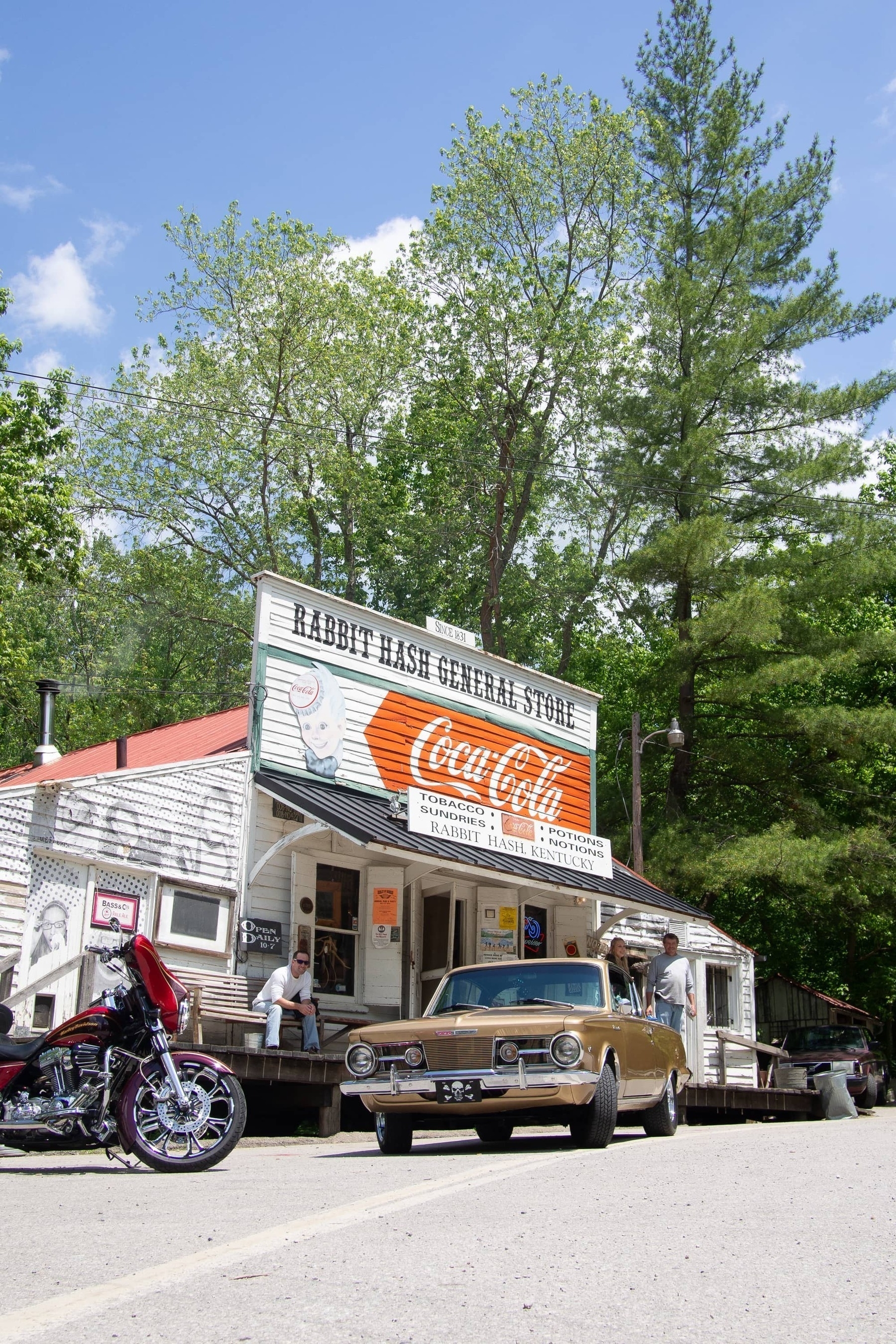 Motorcycle and classic car in front of an old General Store - Olympus E-M5