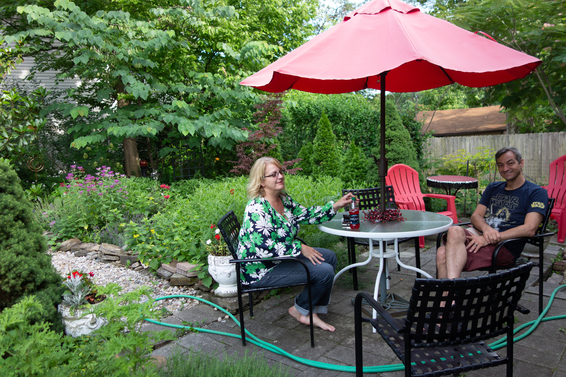 Sister and brother outside at a table in the garden - Sony RX100