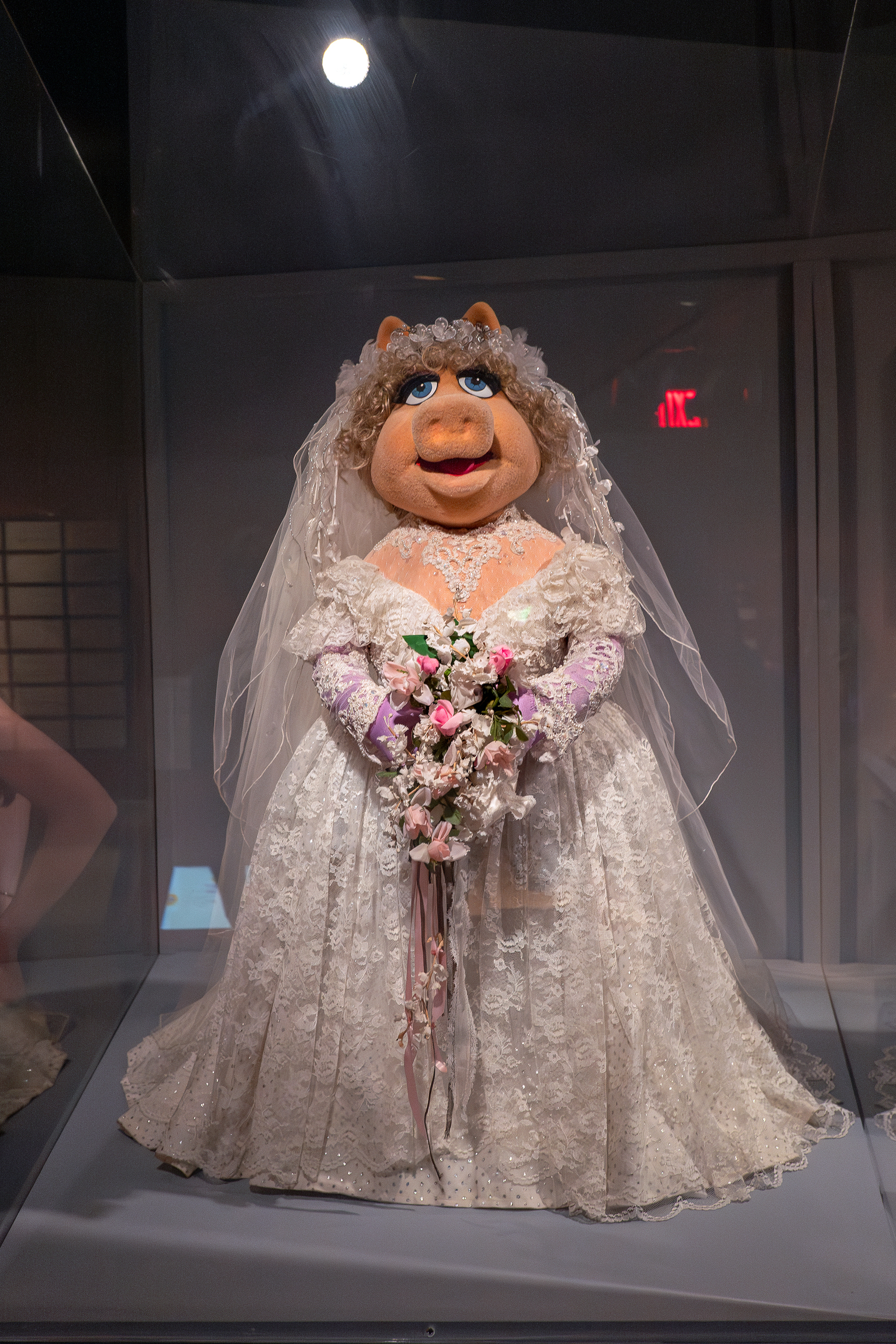 Full body Miss Piggy Muppet in wedding dress on display in a case - Leica Q