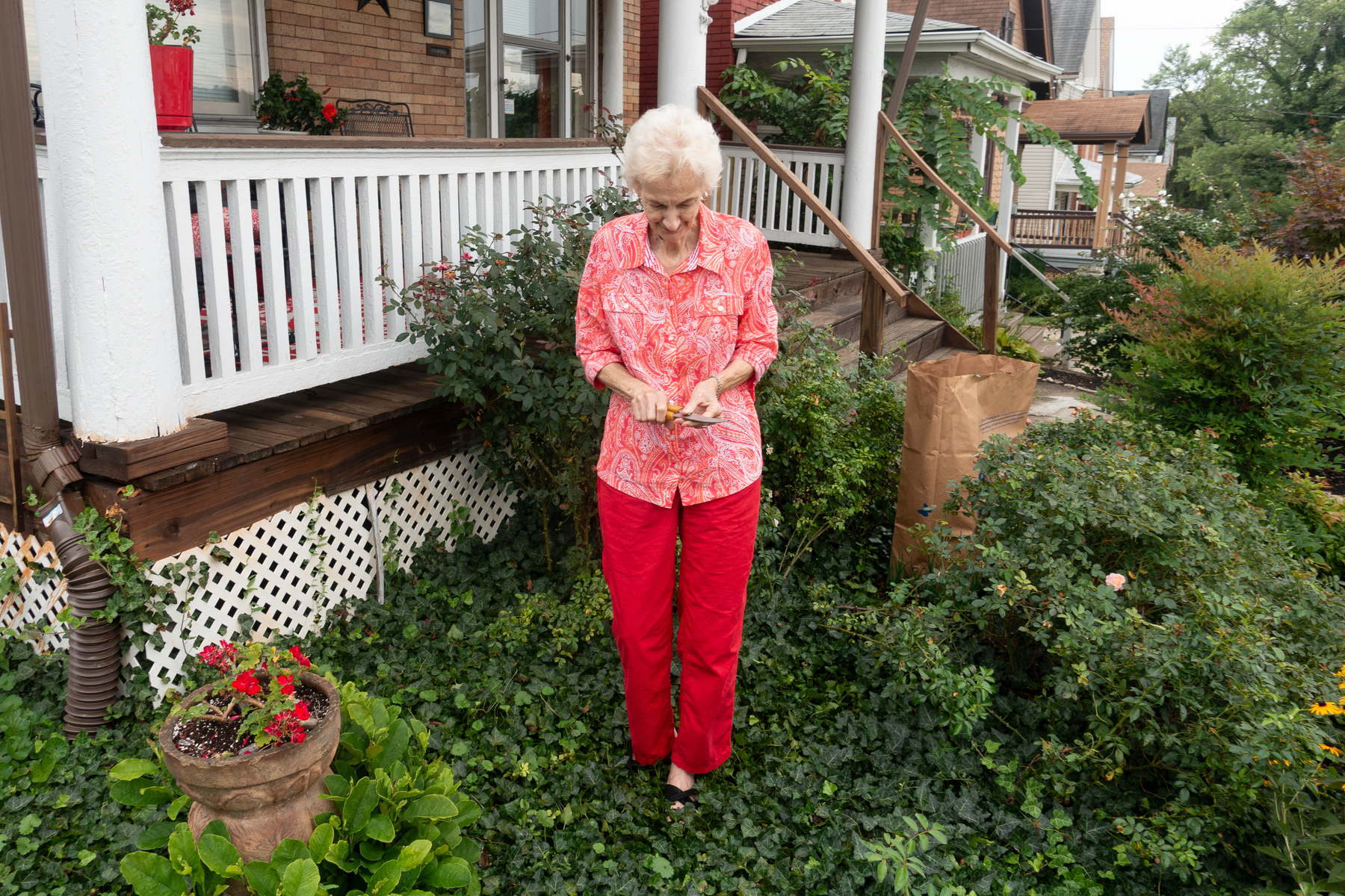 Mom, coordinated outfit, pruning shears in hand, standing in ivy by the rose bushes she was trimming - Sony RX100 