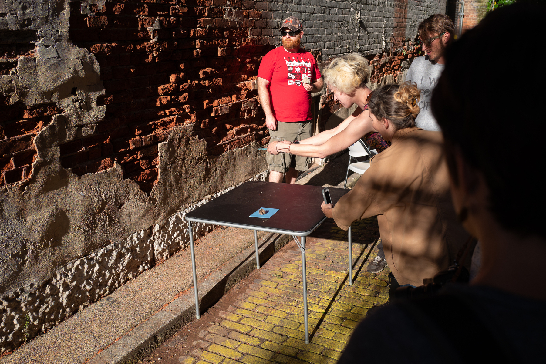 Photographing a spiked Sweet Gum ball on photo sensitive paper in an alley - Leica Q