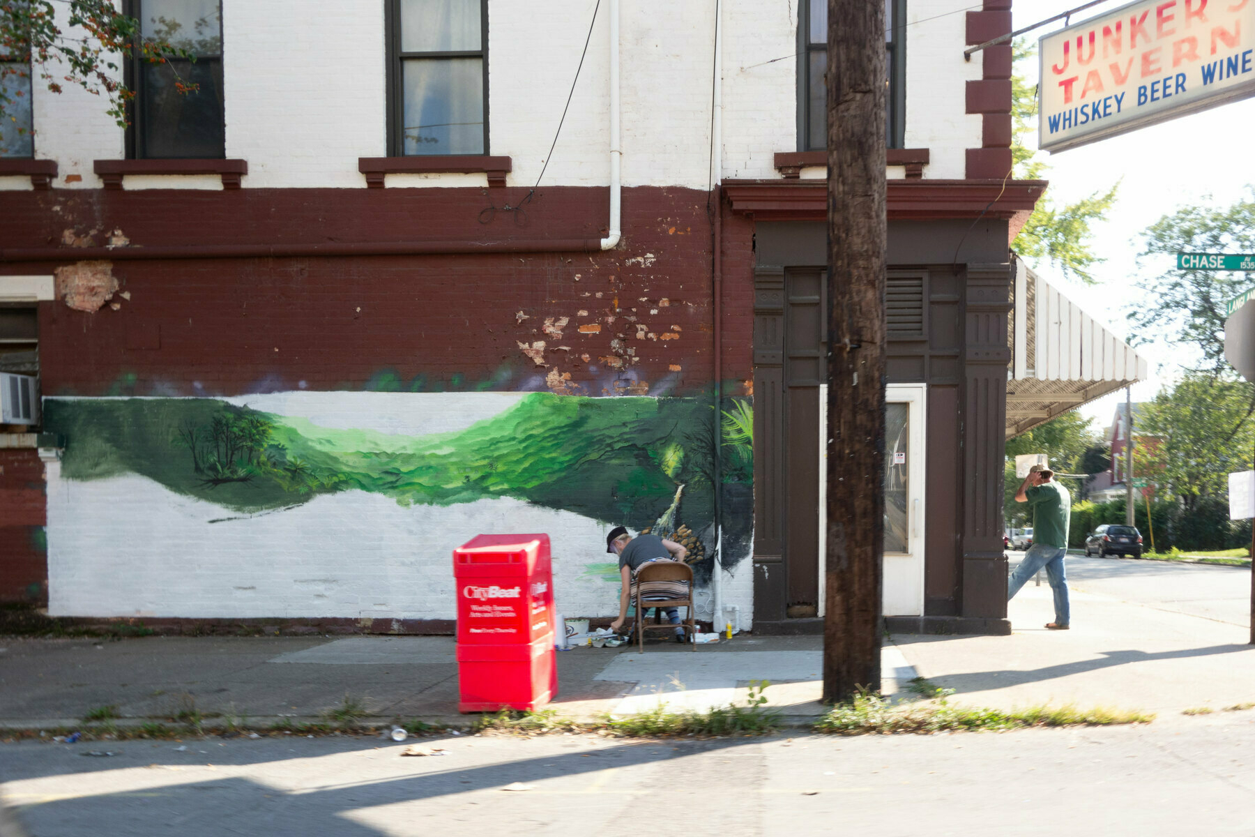 A person starts a mural on the outside of a bar - Sony Cybershot