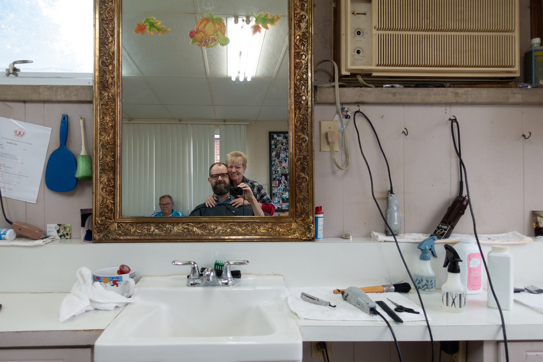 Me in a barber chair taking a selfie with my barber Tiny Tina who was celebrating her birthday - Sony RX100