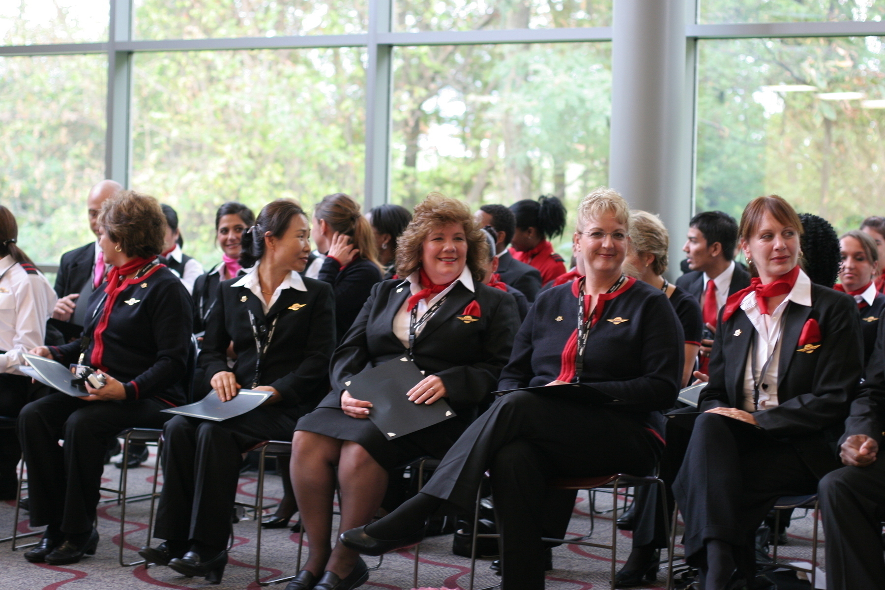 My sister (looking at the camera) sits at a ceremony to get her certification to be a flight attendant - Canon 20D