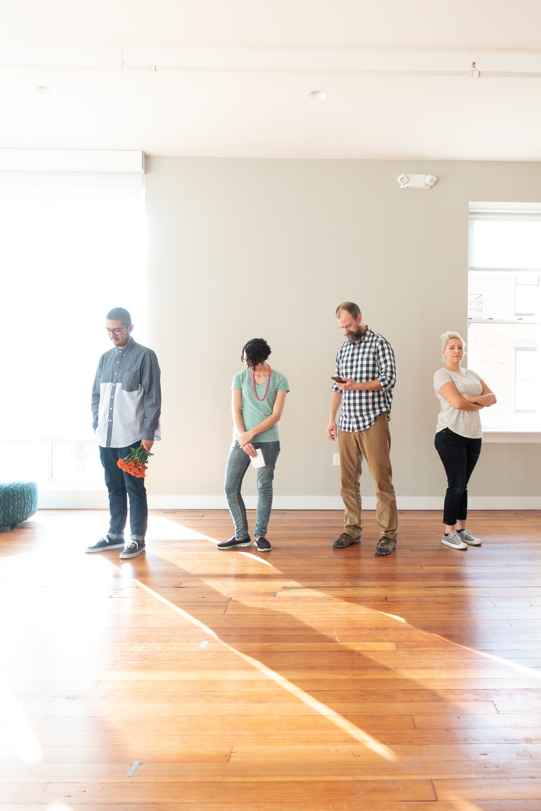 Photograph of 4 individuals, 2 forlorn, 1 defiant - Sony RX100