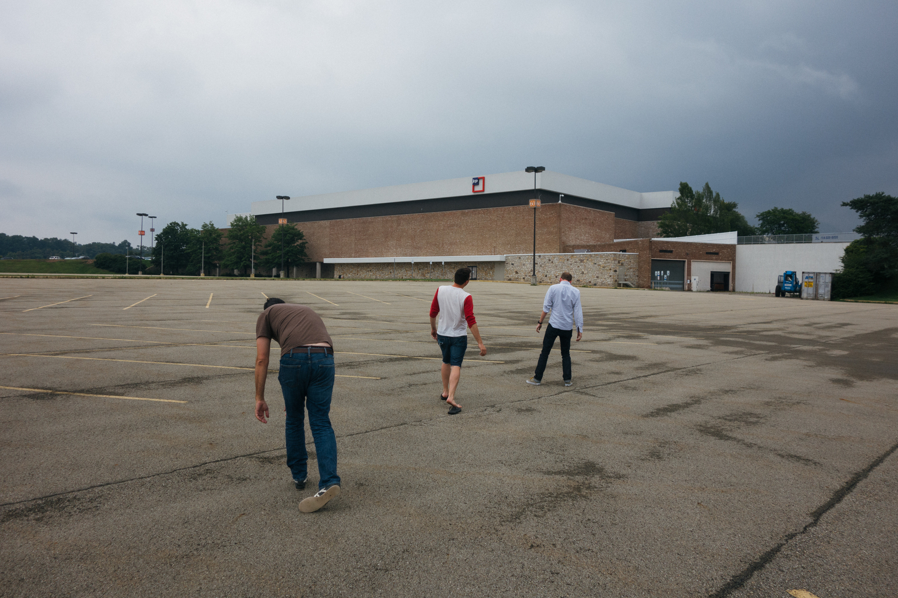 Three zombies walk toward a JCPenney when it had that weird square logo for a hot minute - Sony RX100