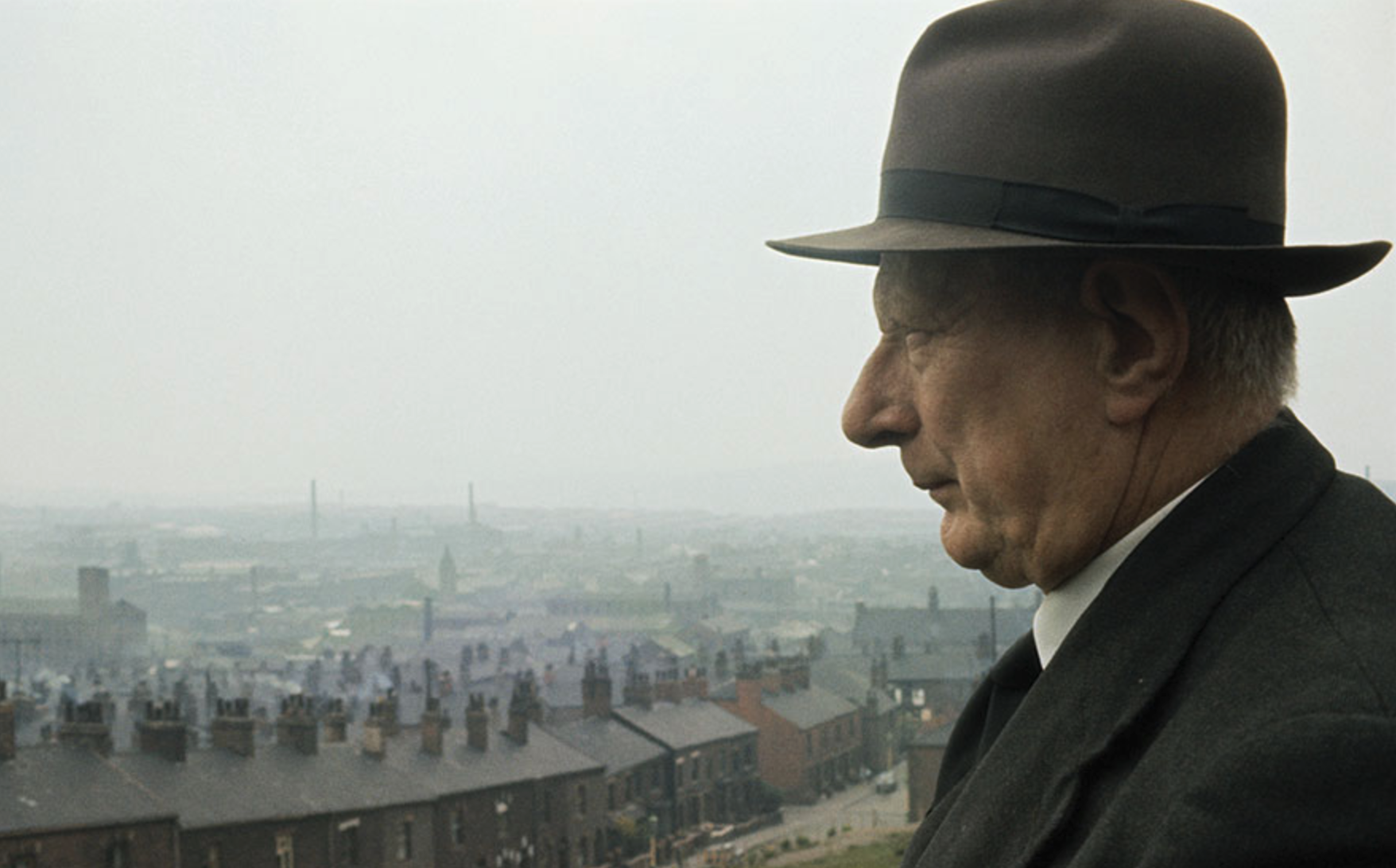 A photograph of Laurence Stephen Lowry with the industrial landscape of Pendlebury, Salford, England in the background (1964) by unknown.  (Laurence Stephen Lowry (1887 - 1976), English artist.)