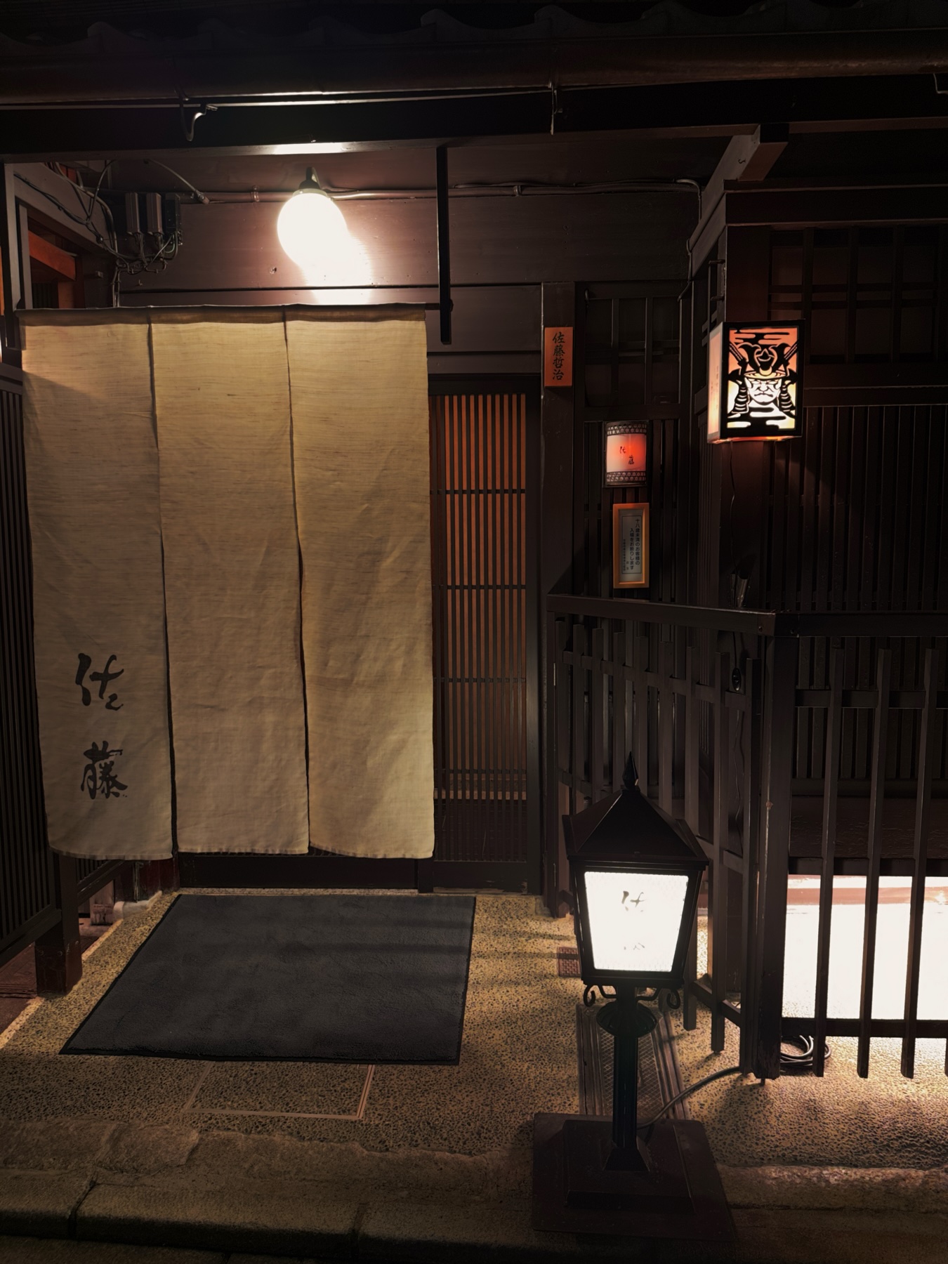 Entrance to a Kyoto restaurant with a lantern portraying a samurais face