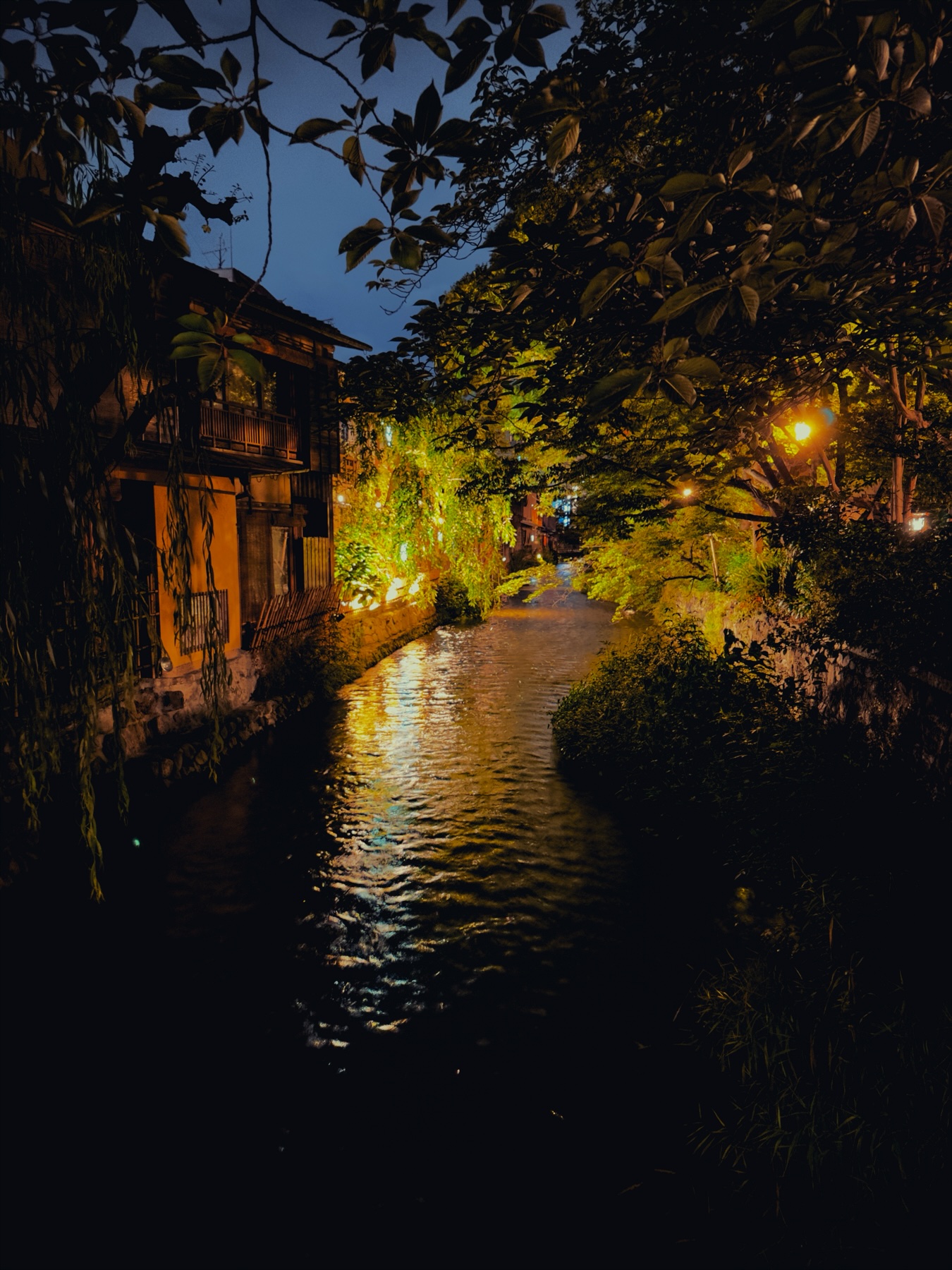 A river in Kyoto&rsquo;s old town at night. Light reflecting off the surface
