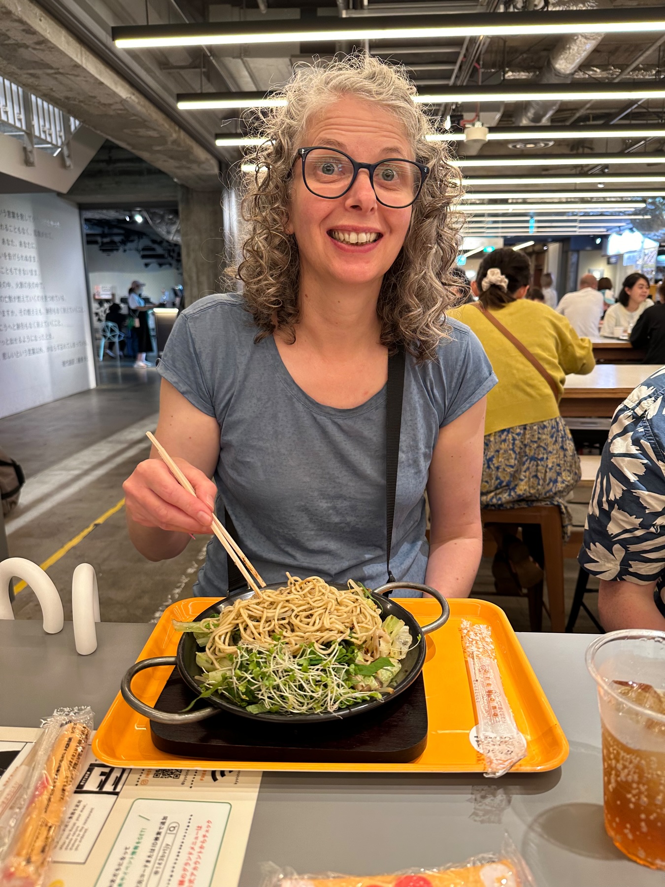 My Wife eating vegan noodles with lots of green stems
