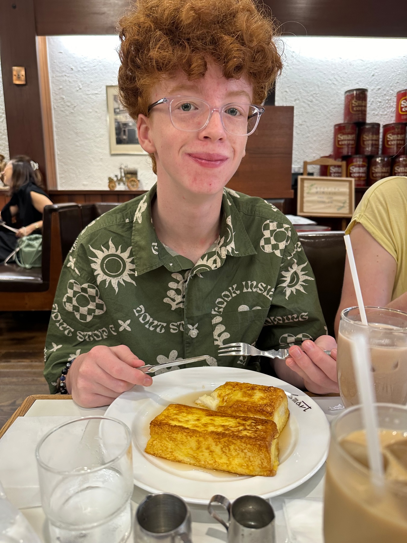 My son in front of a plate of large thick french toast