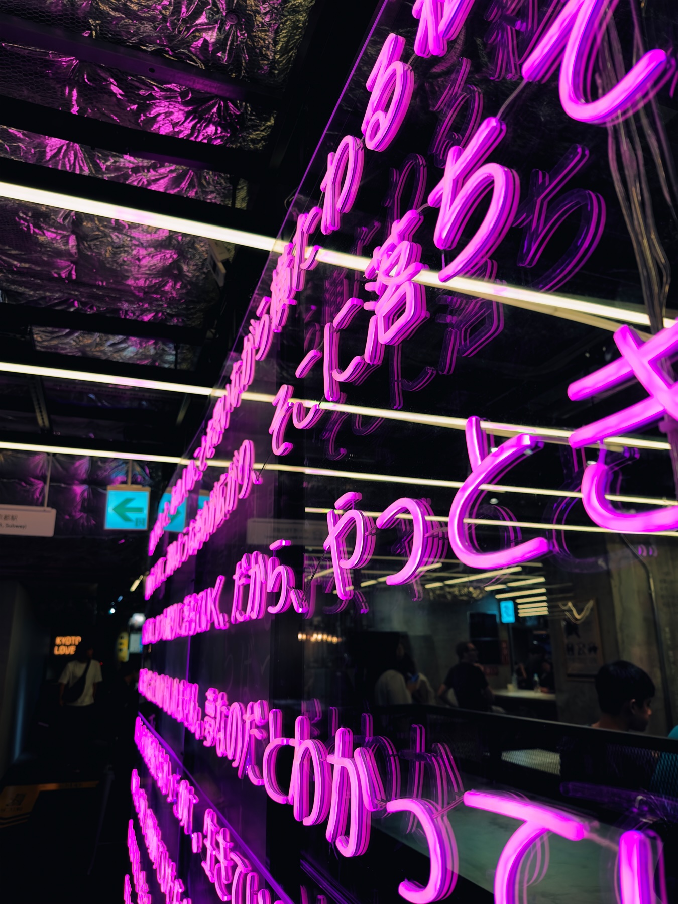 Purple neon sign of japanese writing in the food hall