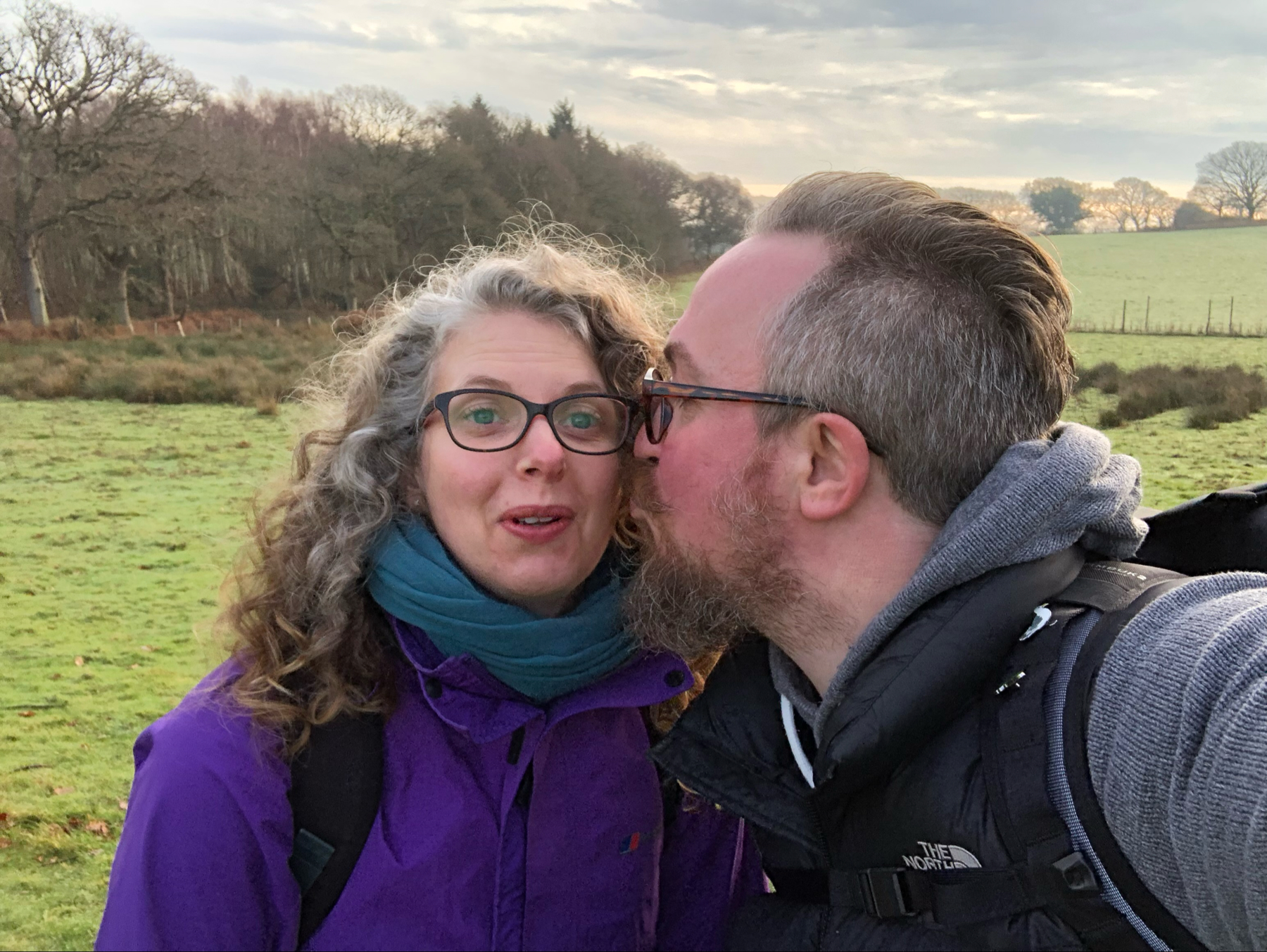 Me kissing my wife on the cheek as she looks surprised!