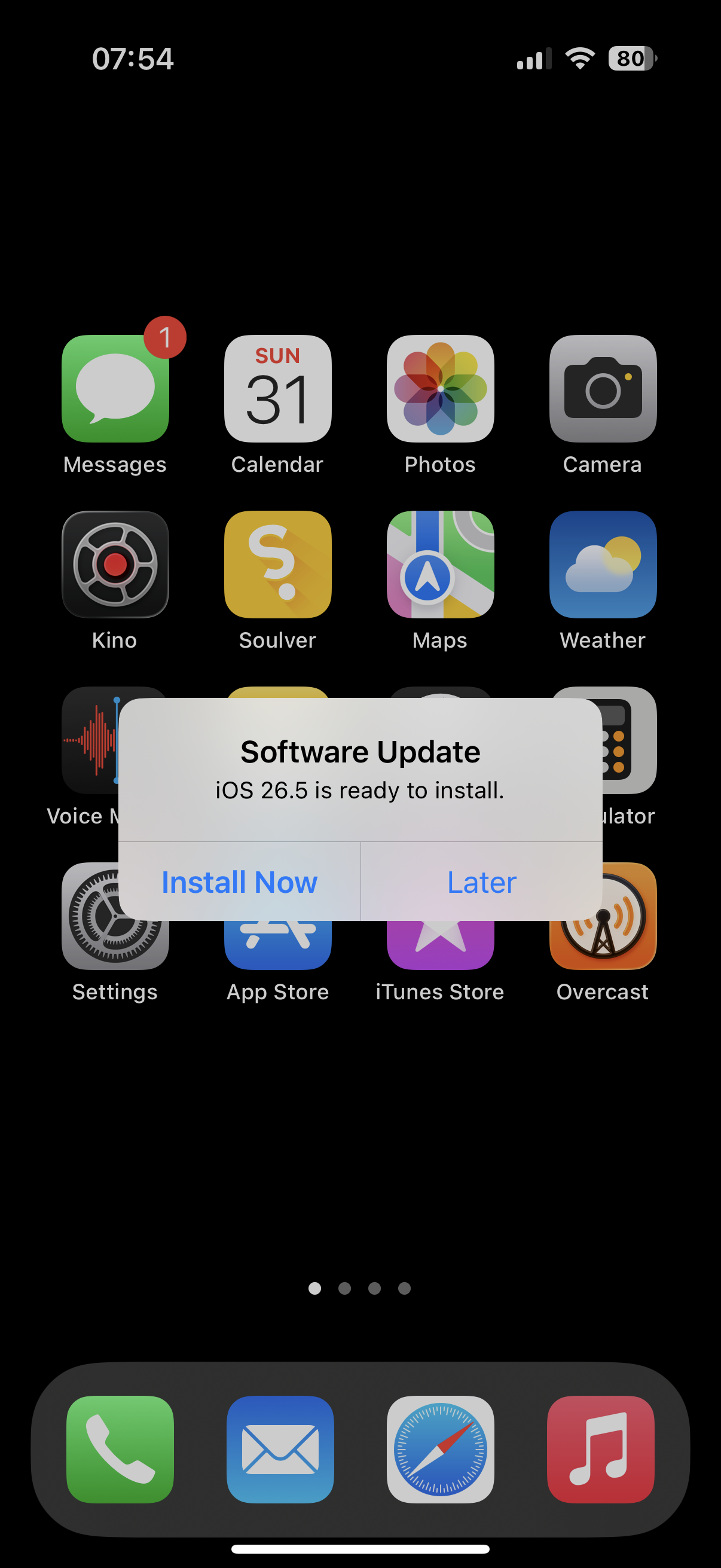 iOS HOME SCREEN with a modal alert. Software Update. iOS 26.5 is ready to install. Install Now, Later.
