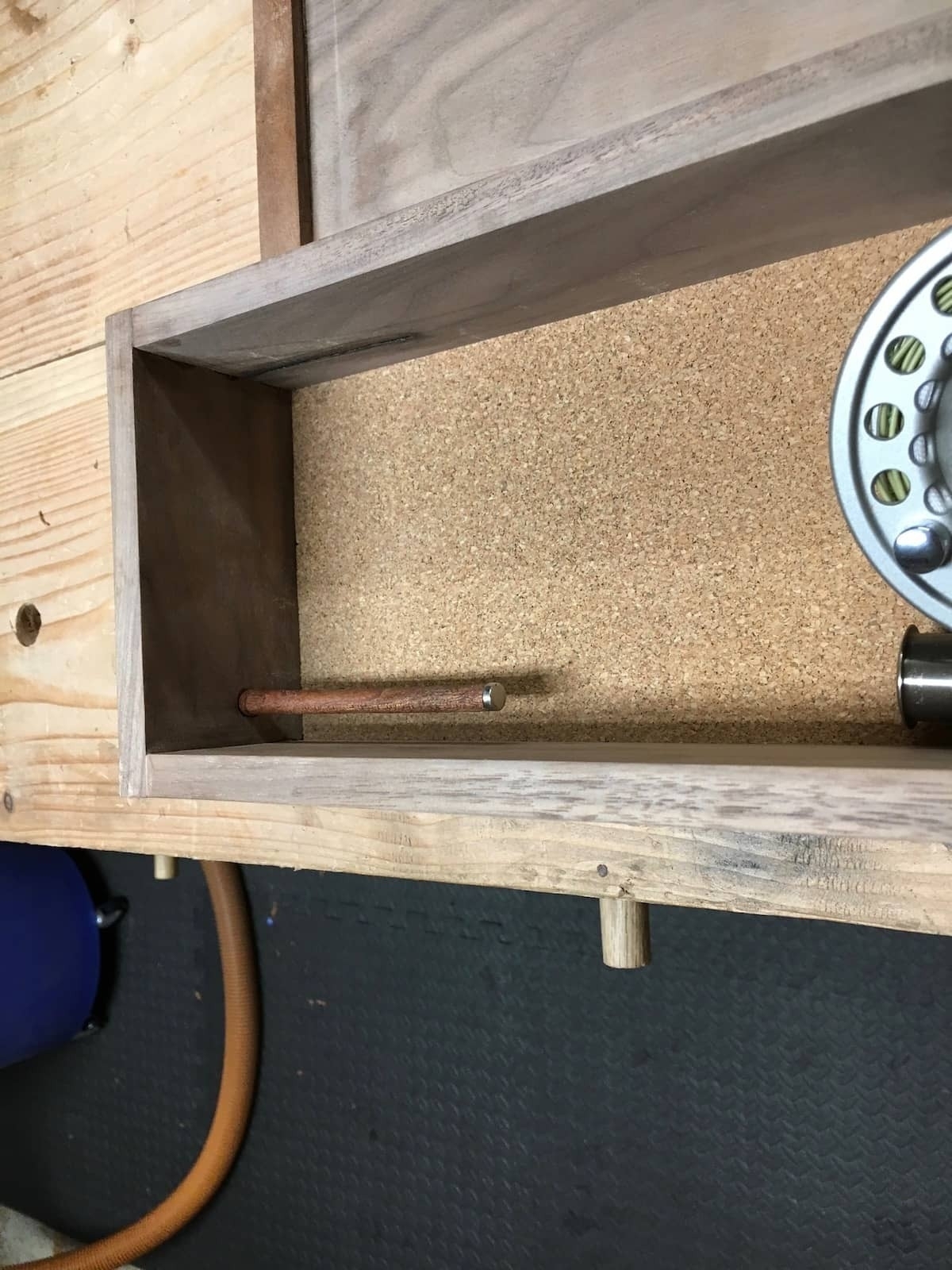 dowel attached to box, used to hold the reel