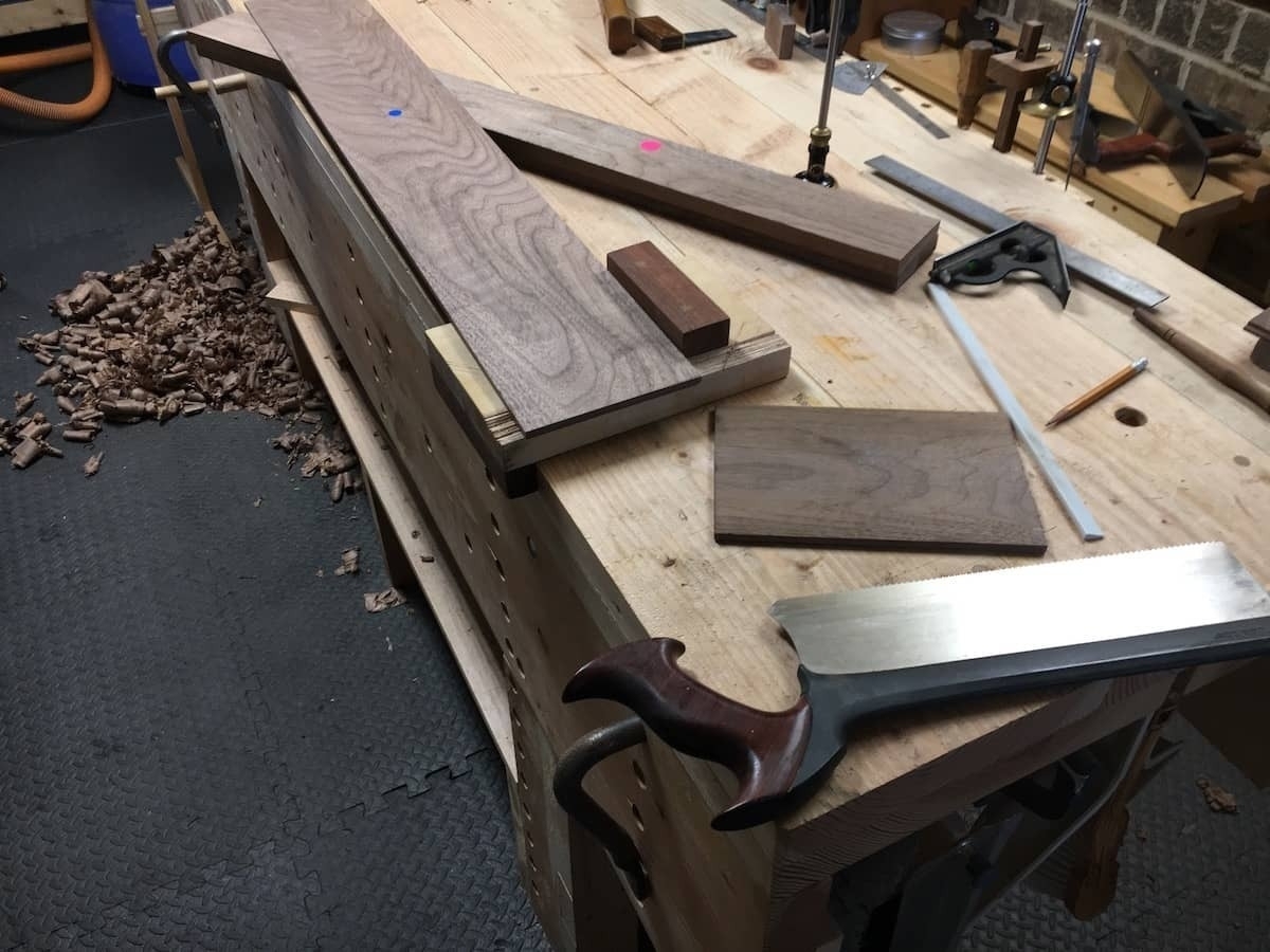 Cutting boards to length with crosscut carcass saw.