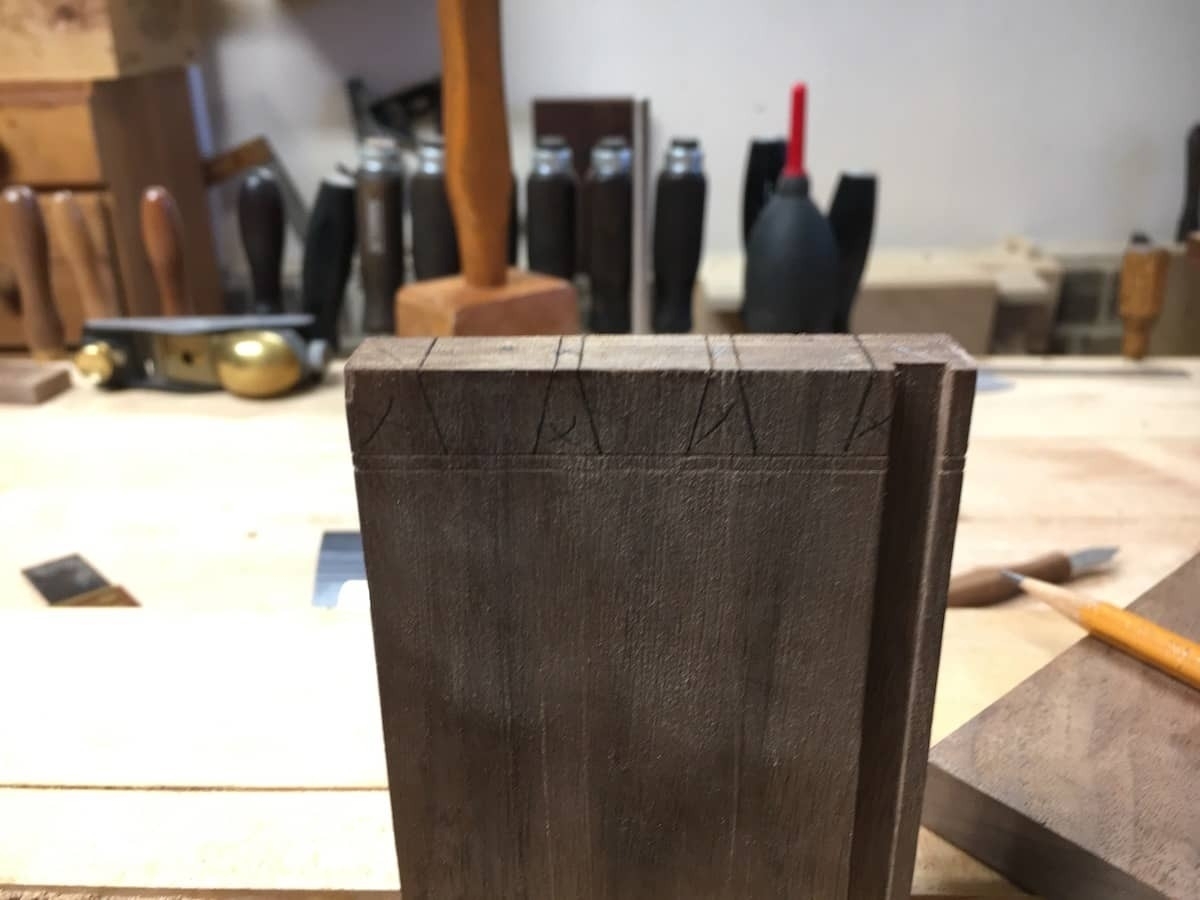 End panel with pencil marks for dovetail cuts