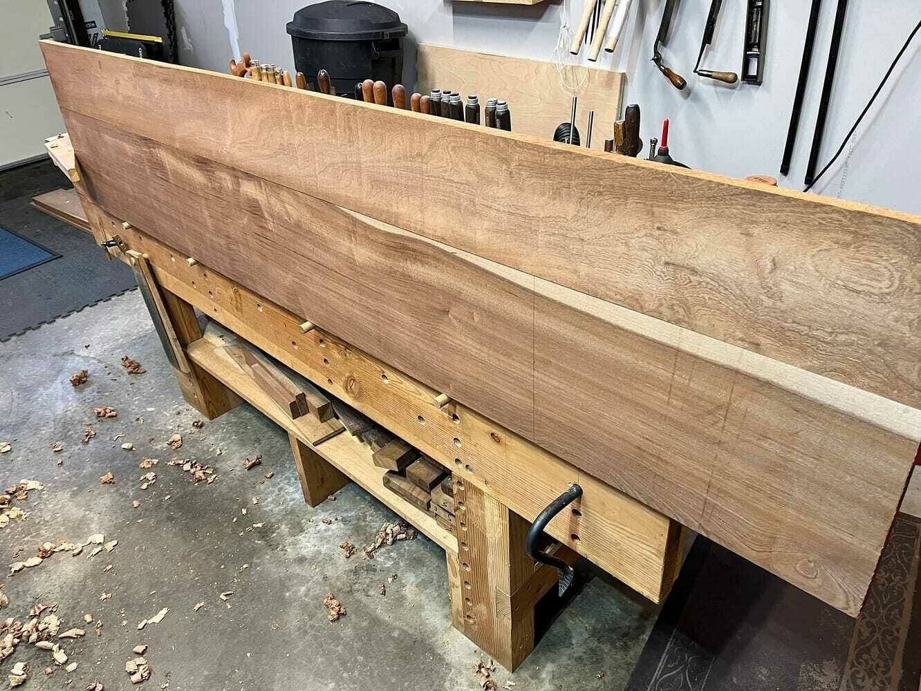 two long sapele boards aligned and glued together on shop bench.
