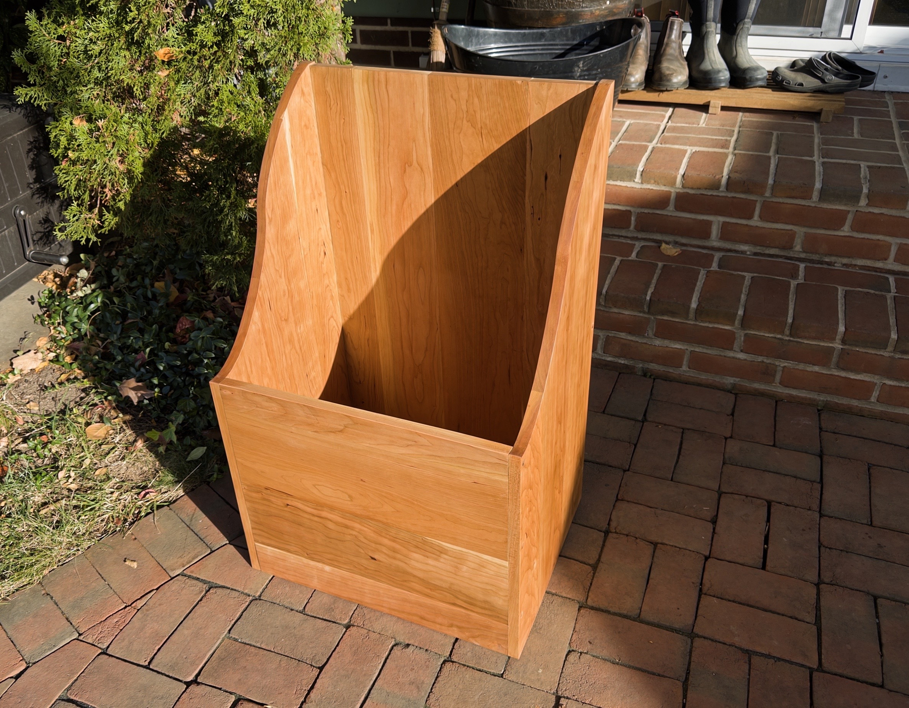 Cherry wood box with curved sides on back porch