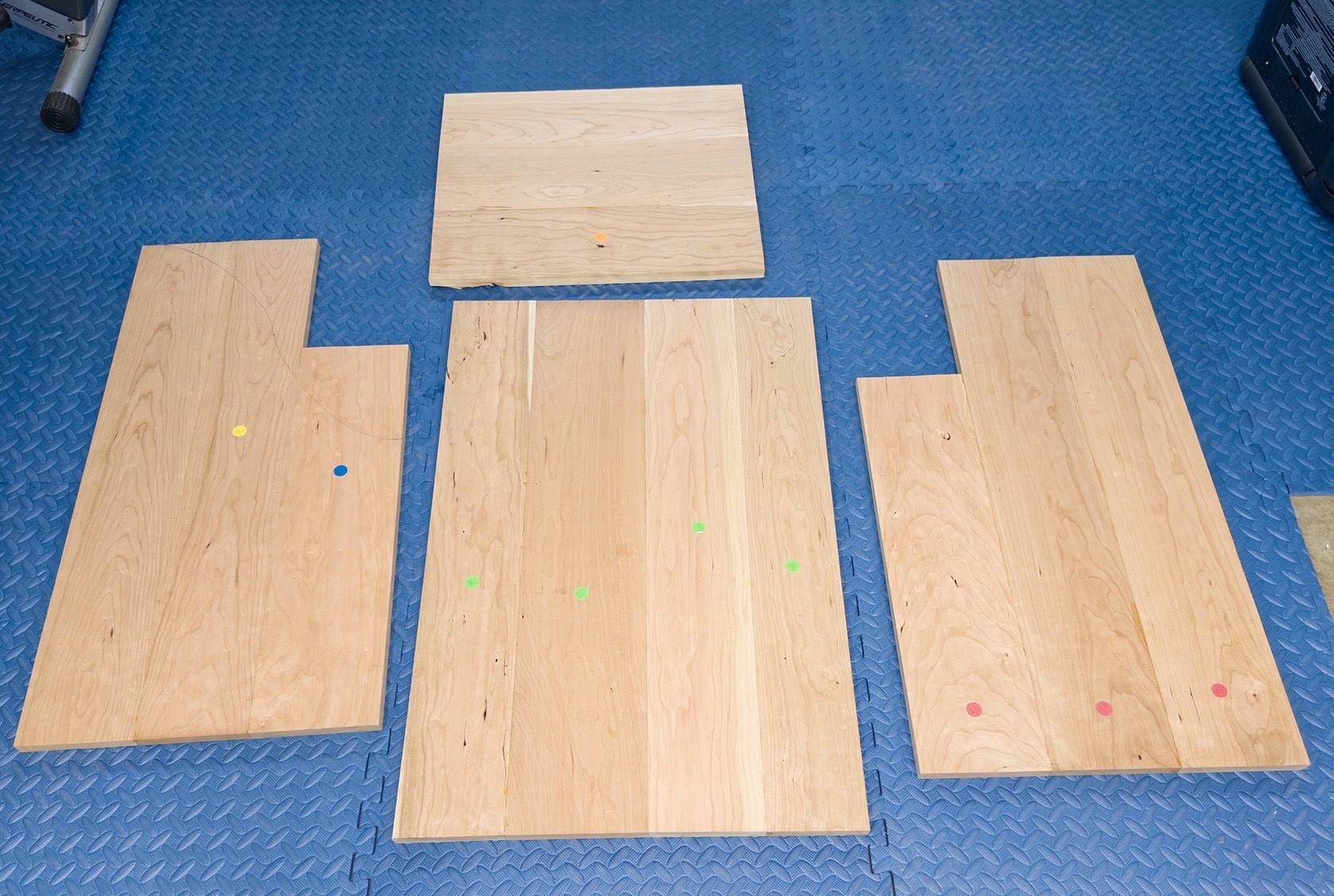 the cherry wood parts of a new firewood box layed out on the floor