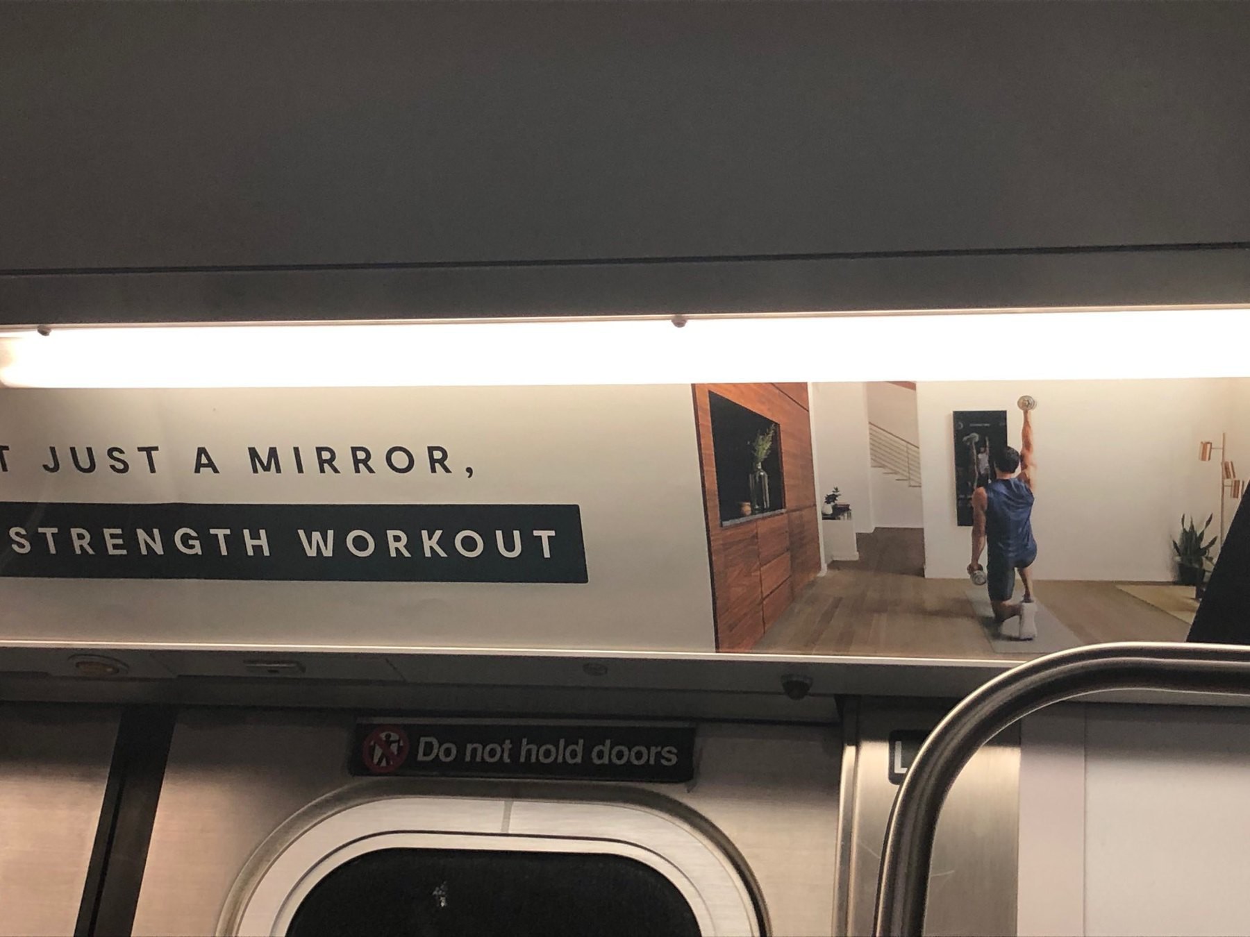 Subway add for a "Mirror" (TM). Apparently a giant smartphone for exercise at home. 