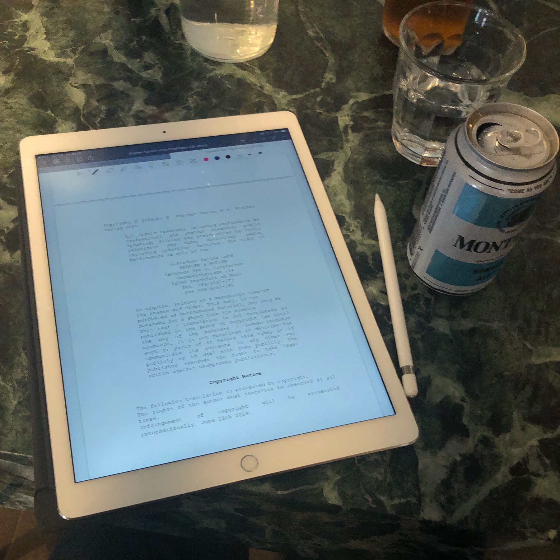 iPad with play script next to beer can