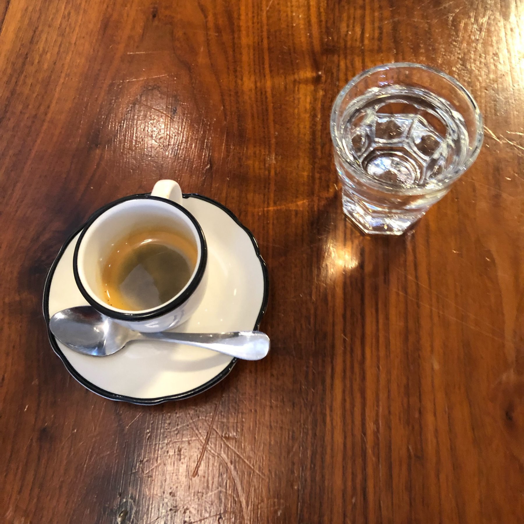 Sparkling water shot next to an espresso. 