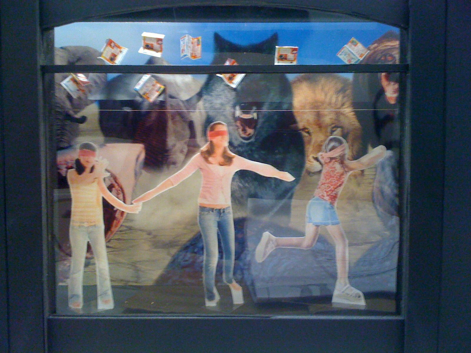 One inch scale model box of a display window. Three pre-teen girls wearing blindfolds as huge predators bear down on them and abstinence-only pamphlets fall from the sky.