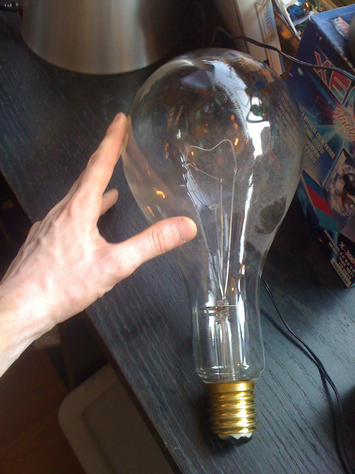 My hand next to a giant light bulb.