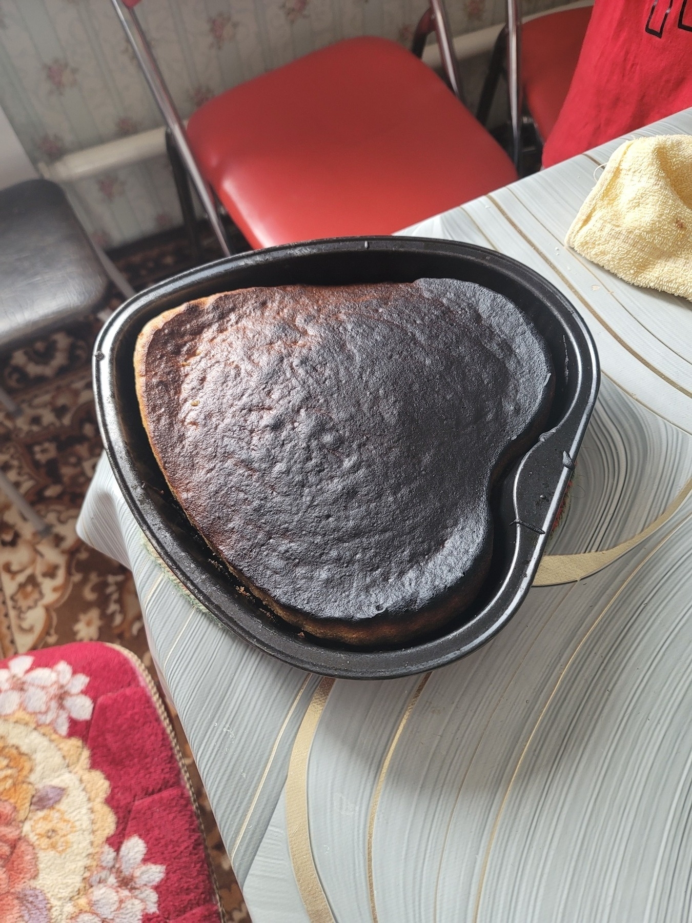 heart-shaped cake in a heart-shaped baking pan. the whole top of the cake is dark, but the top half is significantly darker than the bottom half