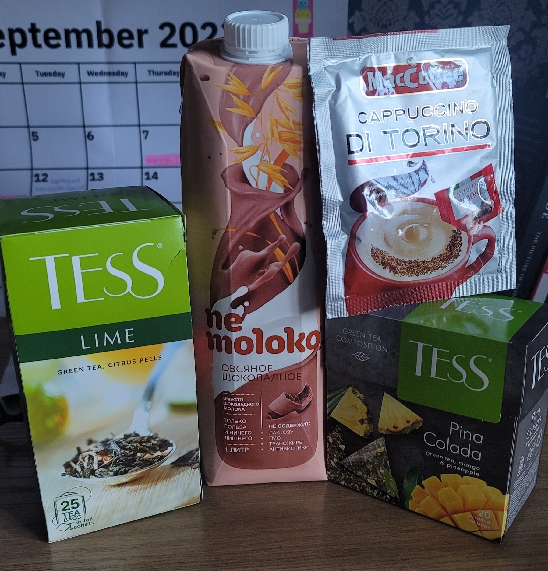 two boxes of Tess green tea; 1 liter Nemoloko carton of lactose free chocolate milk; and a MacCoffee instant cappuccino packet
