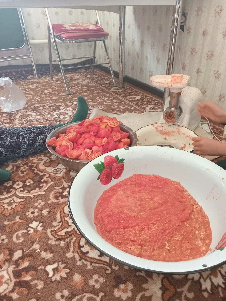 bowl of tomato sauce, second bowl of sliced tomatoes next to an ingredient mincing machine