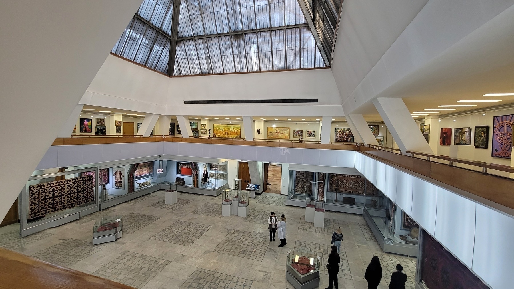 view of two floors of a museum atrium, taken from the higher floor