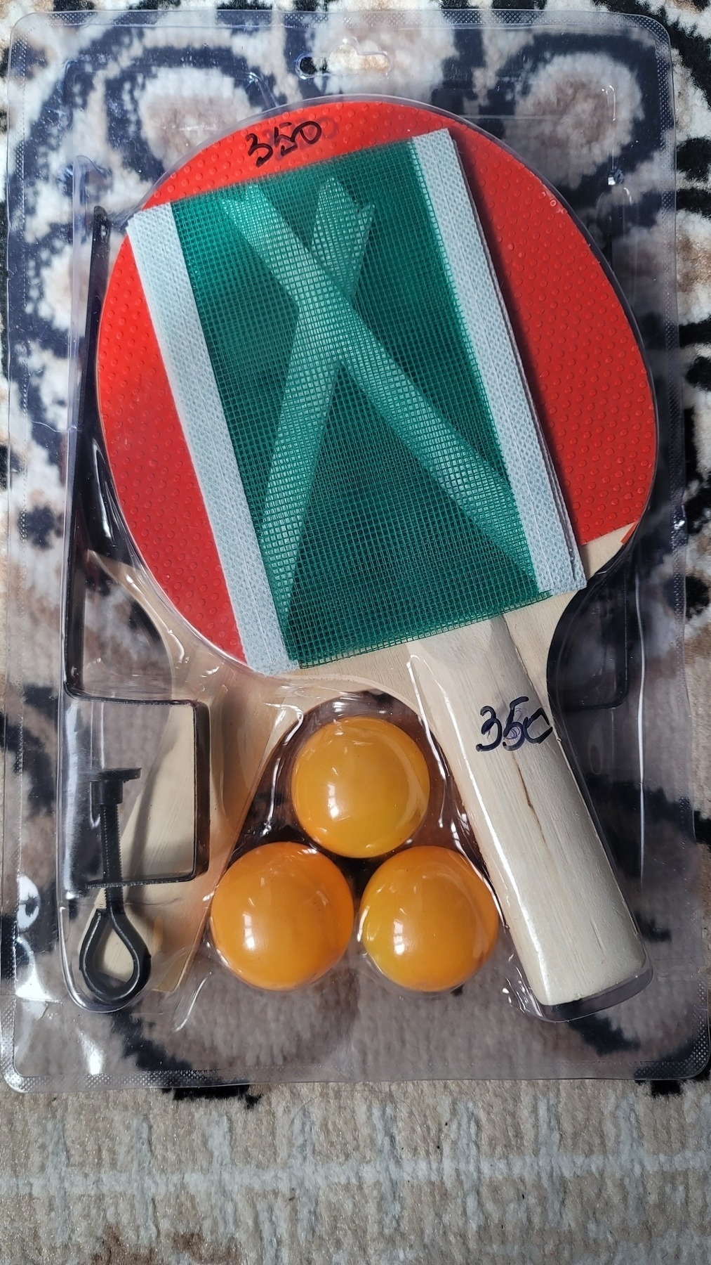 ping pong set in a plastic case including a net, two paddles and three orange balls