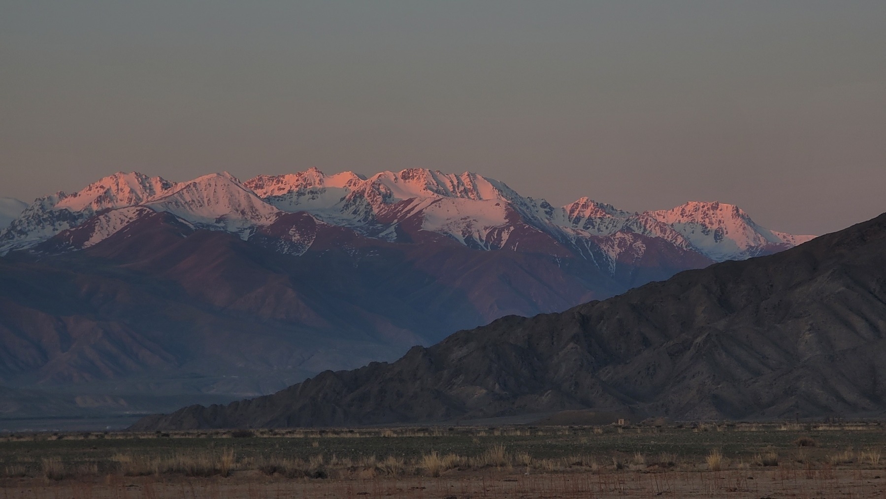 snow-capped mountains with pink morning light reflecting off the tops